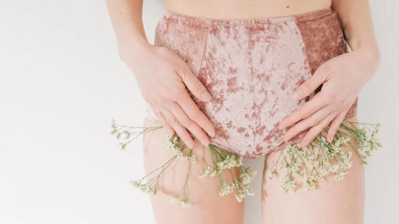 Woman wearing shorts with flowers around the bikini area