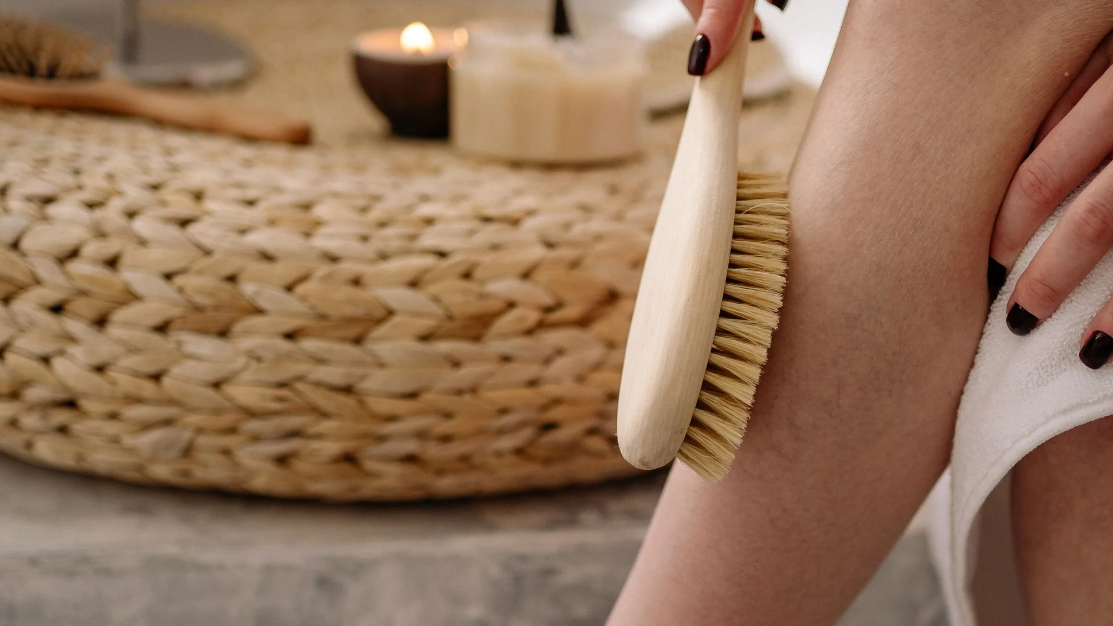 Dry brushing before waxing to exfoliate skin and prevent ingrown hairs