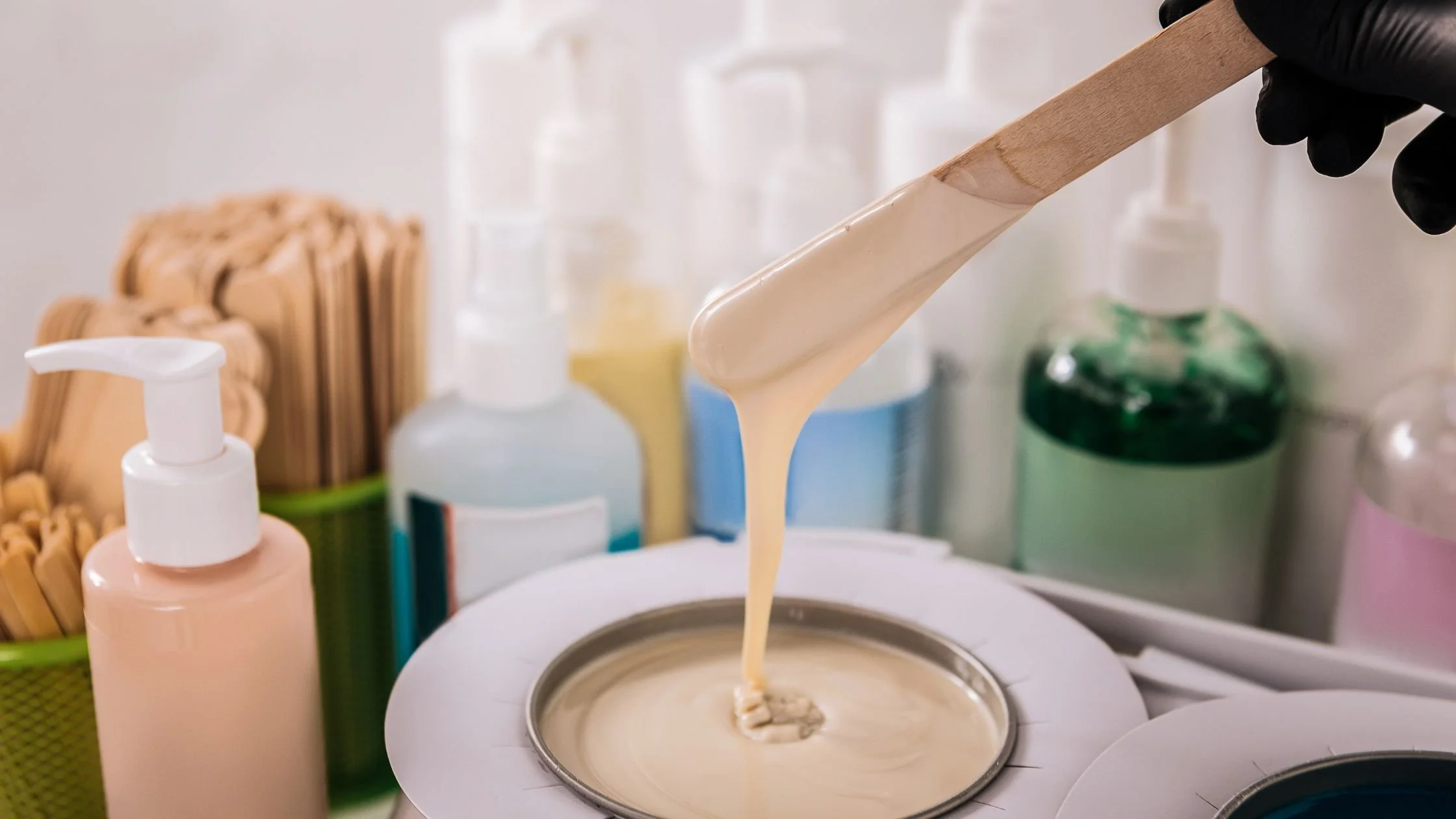 Wax being applied with a wooden spatula