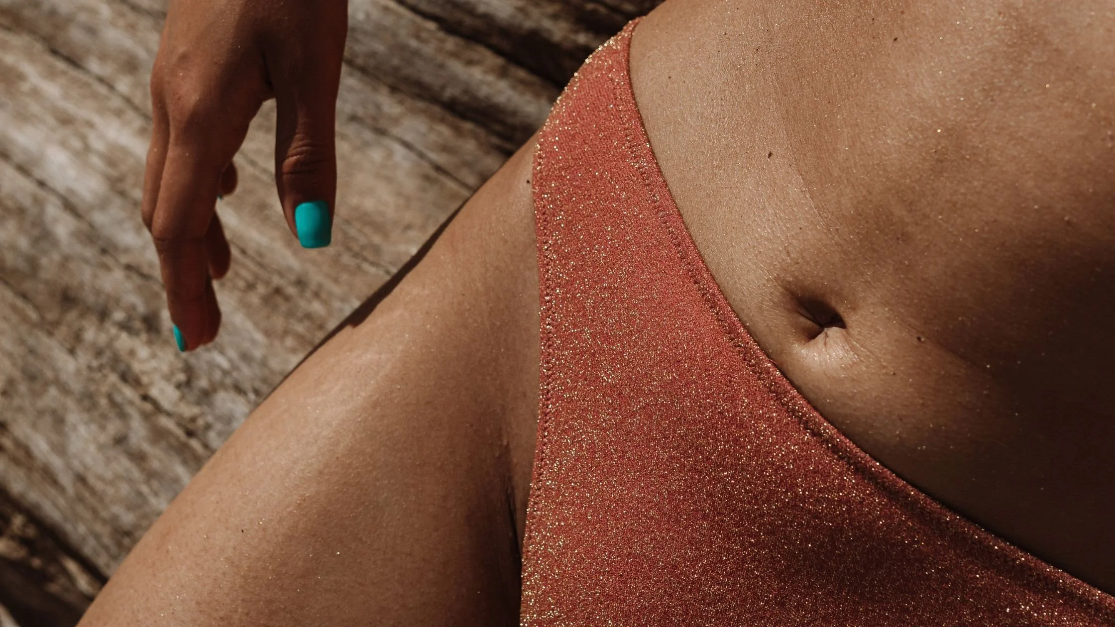 Close-up of a person’s bikini area in a swimsuit