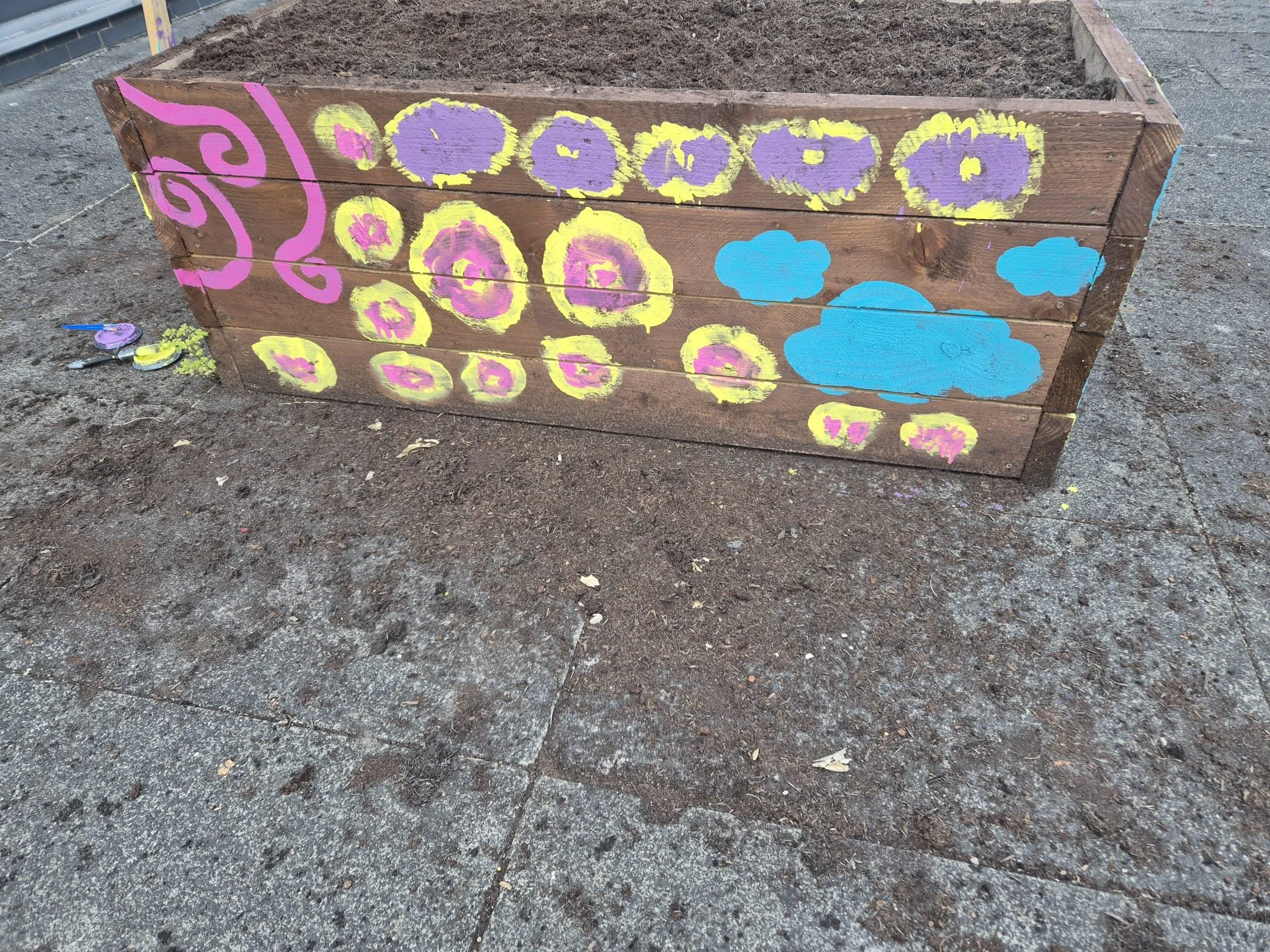Painting planters with our community as part of our Social Prescribing project with The Performance Ensemble