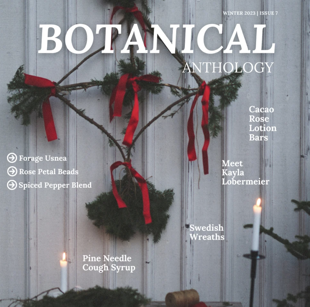 The magazine cover is an image of a Swedish wreath hanging on a white wall with two white candles lit nearby