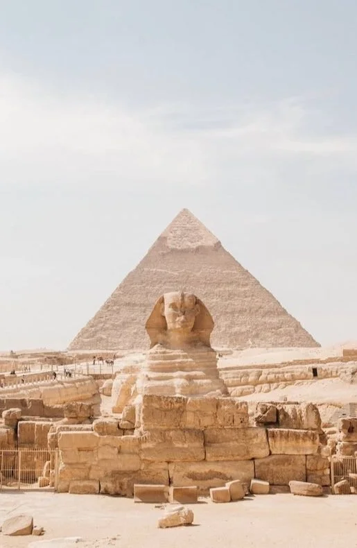 The Great Sphinx of Giza with the Pyramid of Khafre in the background, located in Egypt.