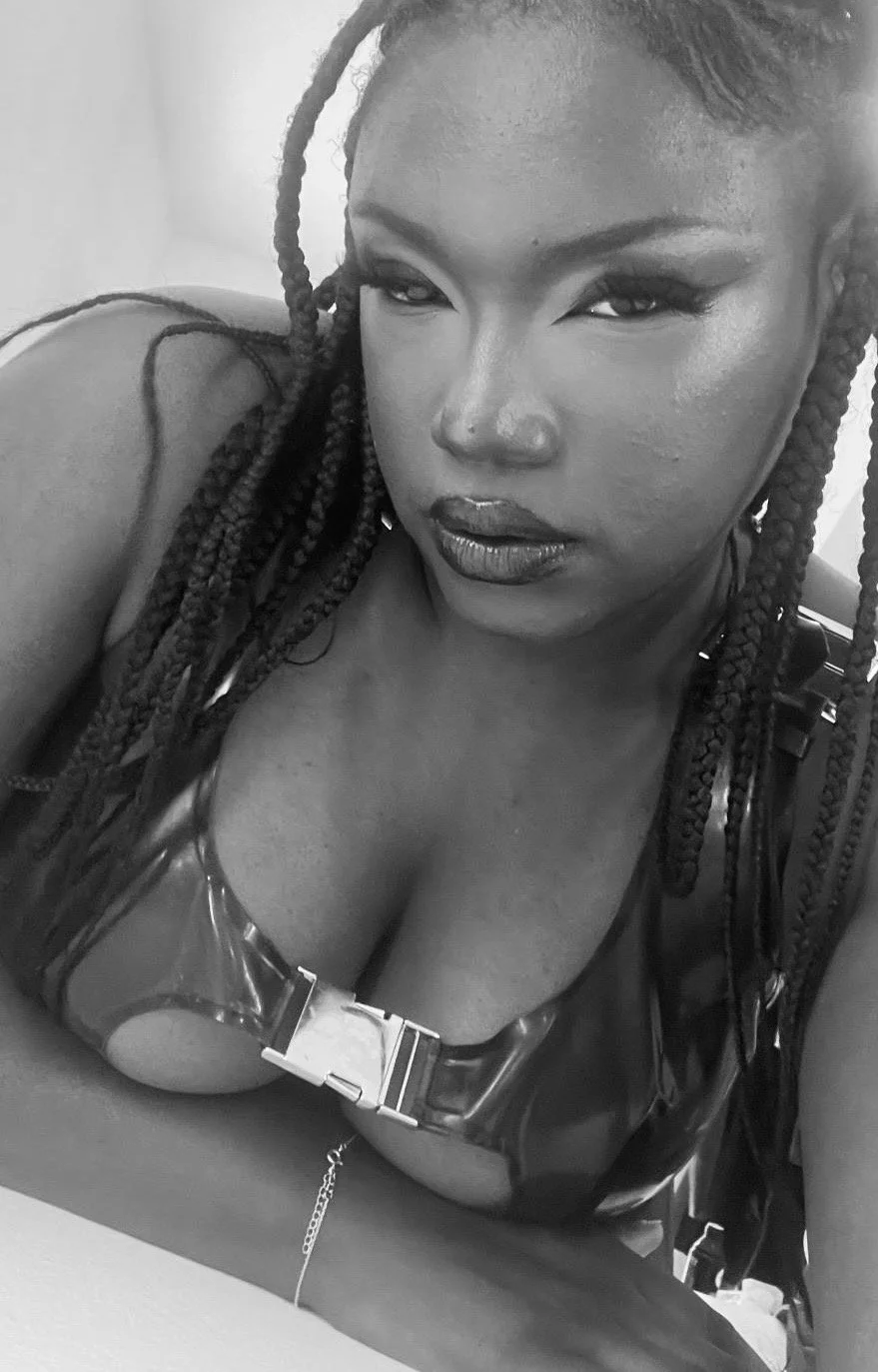 Black and white image of black woman wearing latex