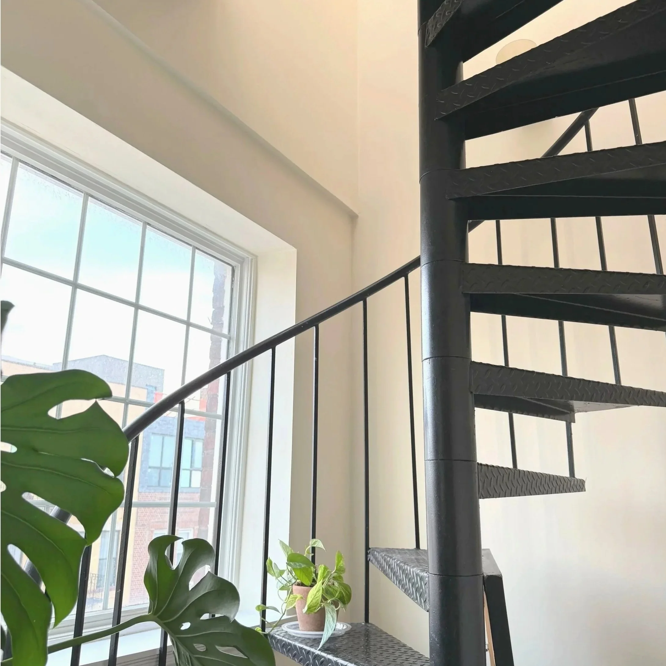 Image of a stairway color drenched in an offwhite paint.