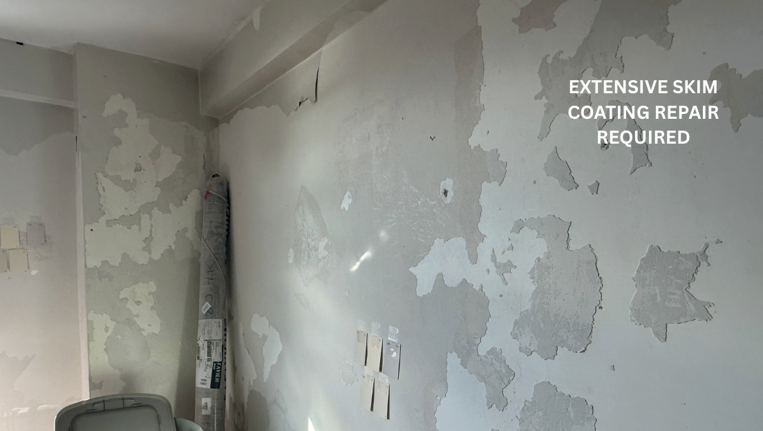 Interior shot of an unfurnished bedroom during renovation showing extensive damage and peeling of walls requiring skim coat repairs and repainting.