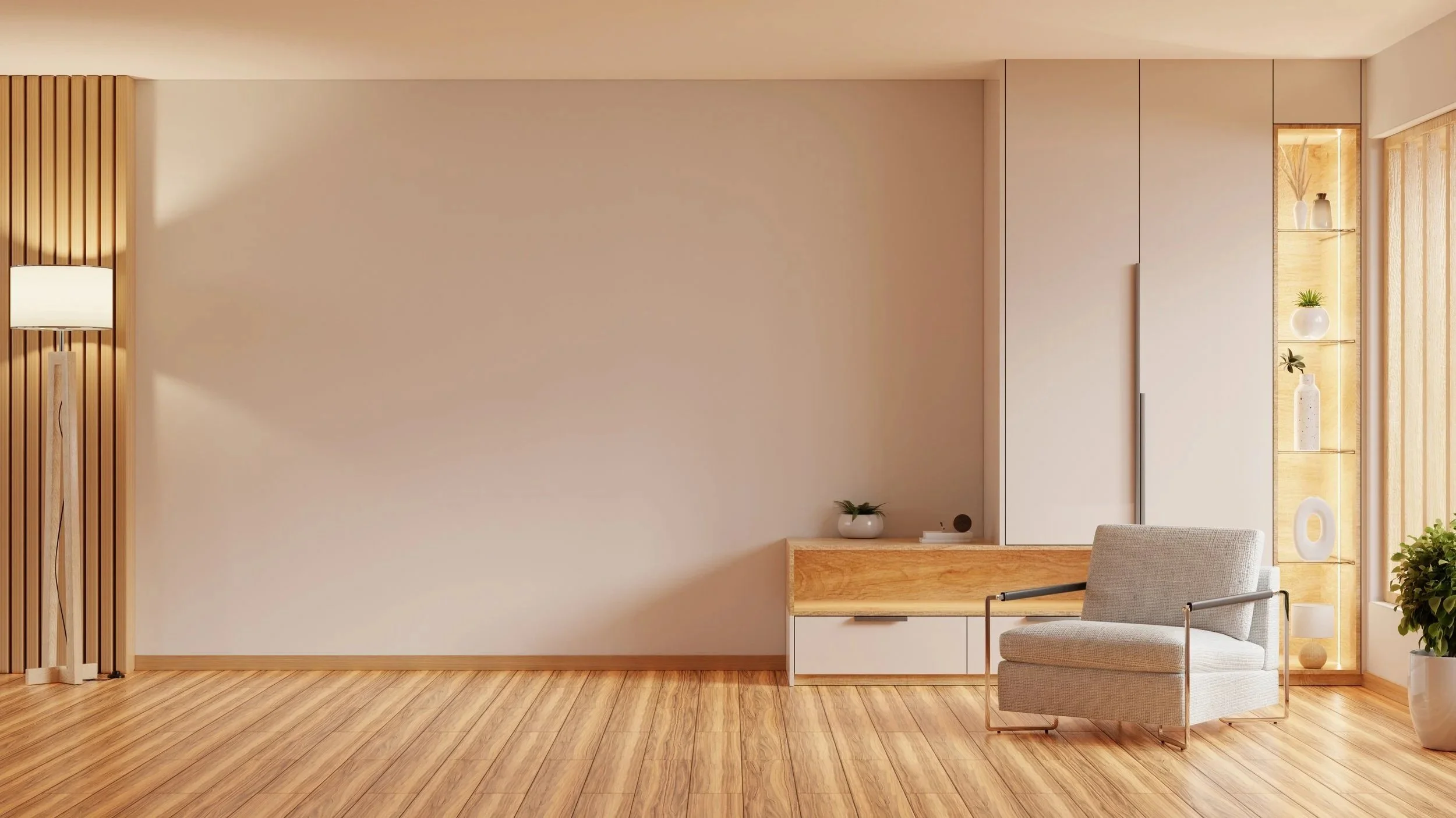 An open living room with wood floors and walls painted beige, with a creme armchair and minimalist wood console cabinet