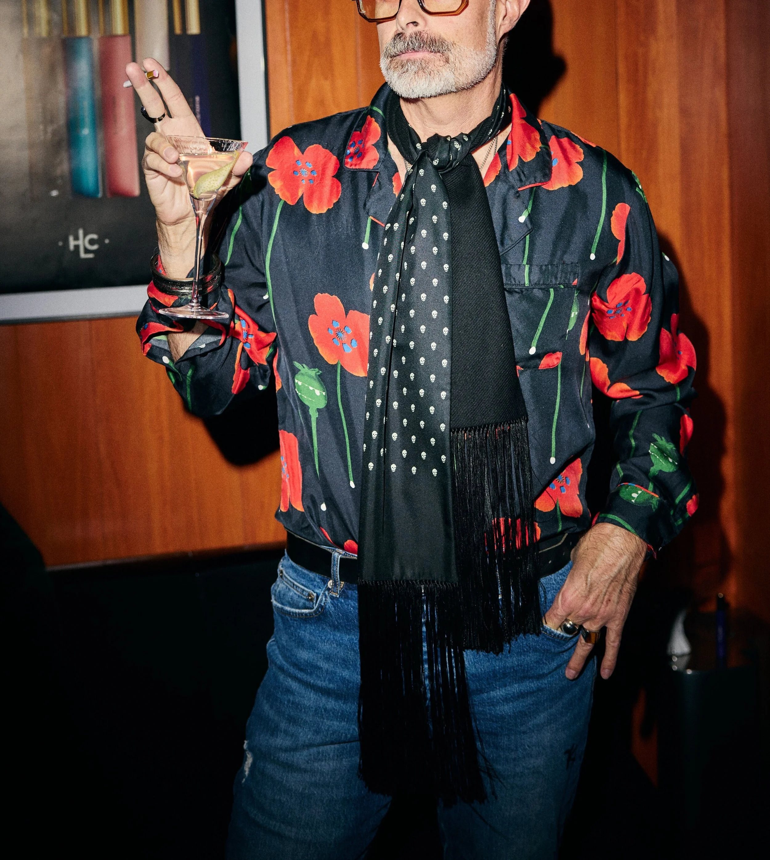 Man with a gray beard holding a cocktail at an upscale cocktail bar in Soho New York