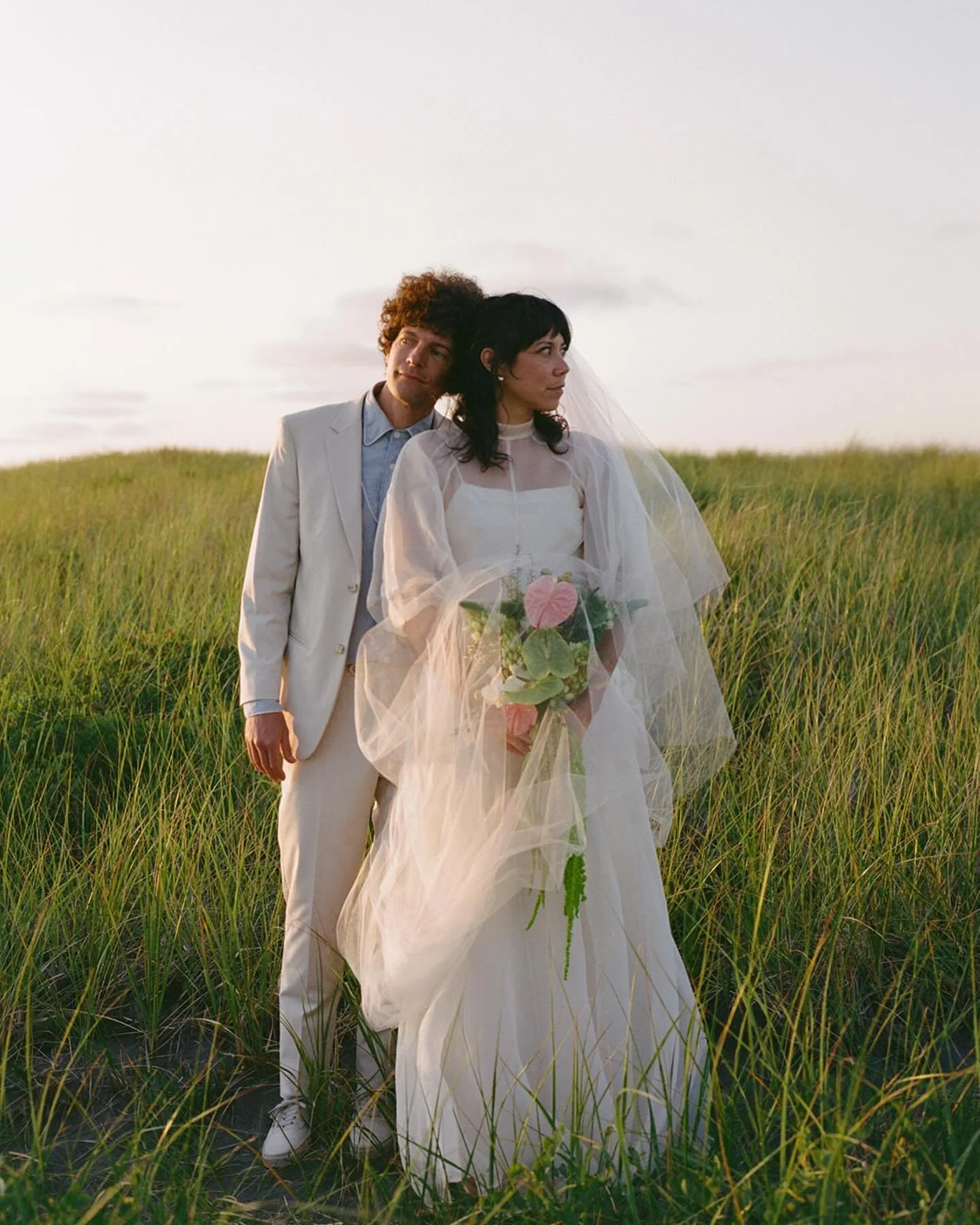 The soft pastels of the coast at dusk, crinkled eyes and the sound of belly laughter, the sun kissing Ash&rsquo;s veil during her ceremony. A wedding day that I could feel, from my head down to my toes, from the tears running down my face to the wind