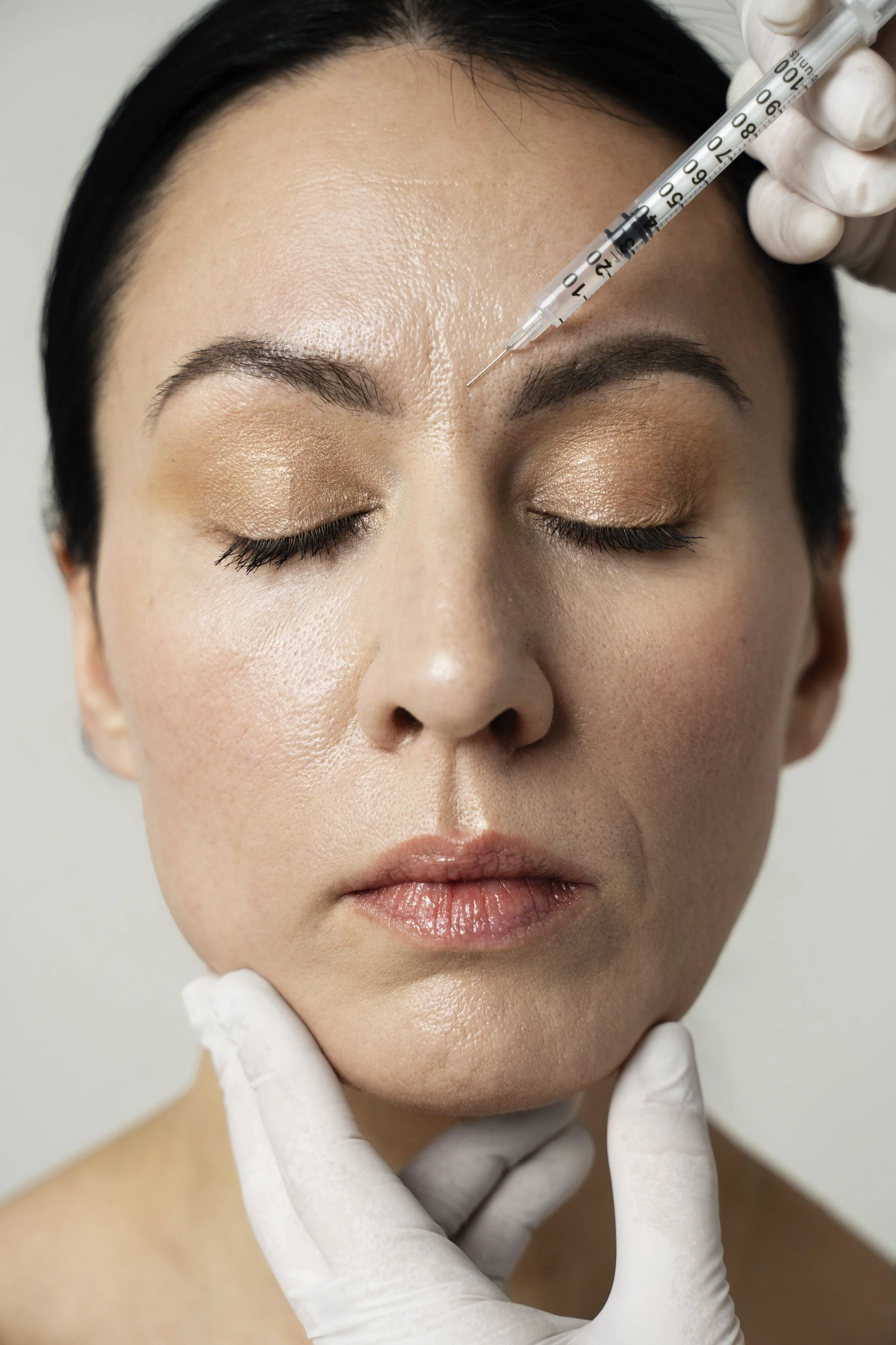 front-view-hand-injecting-woman-s-face.jpg