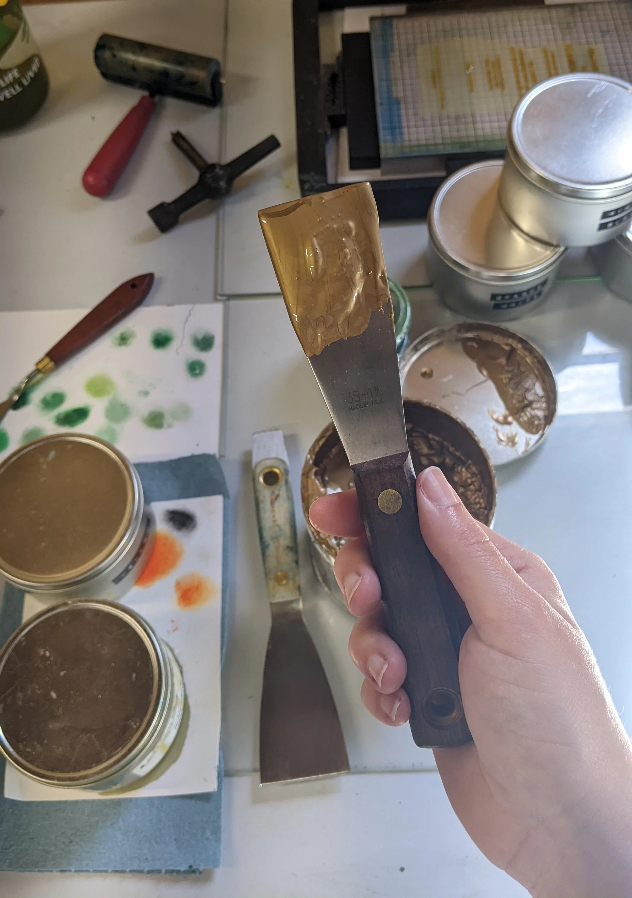 gold ink on a palette knife