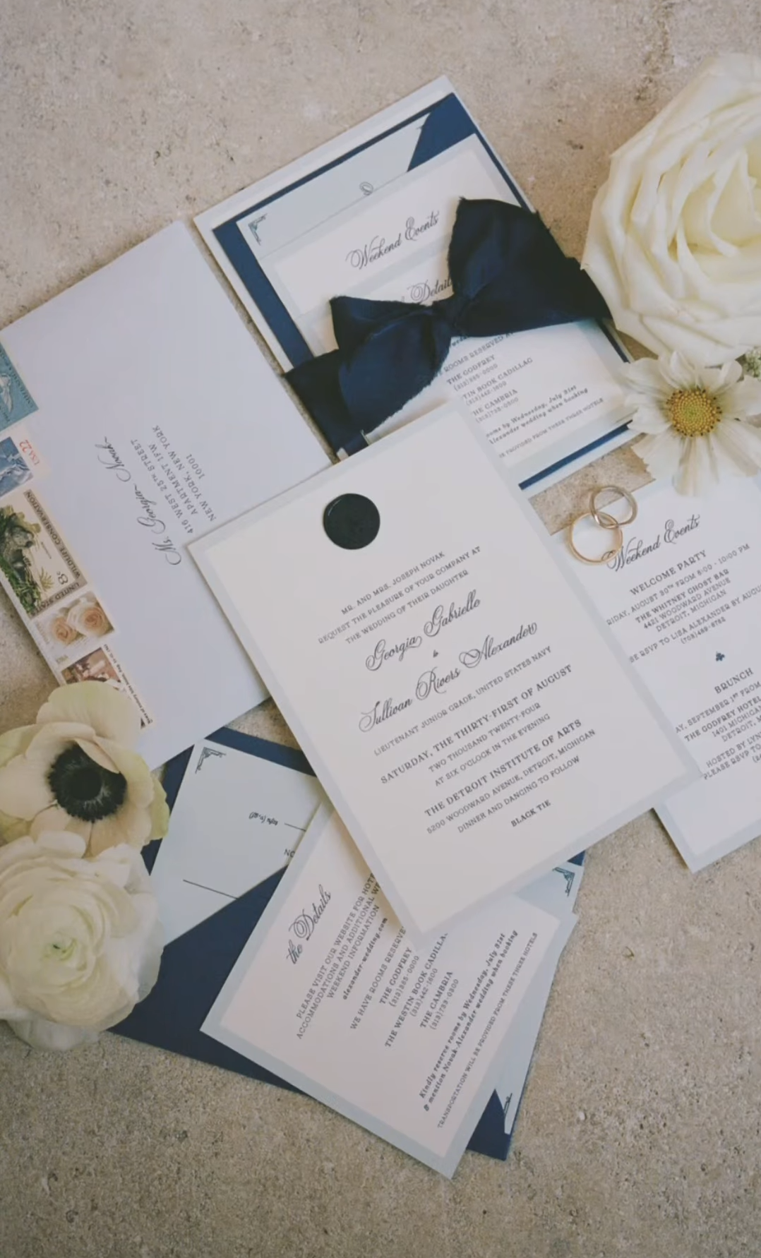 Flatlay of a formal black tie letterpress wedding suite with elegant invitations and classic stationery design