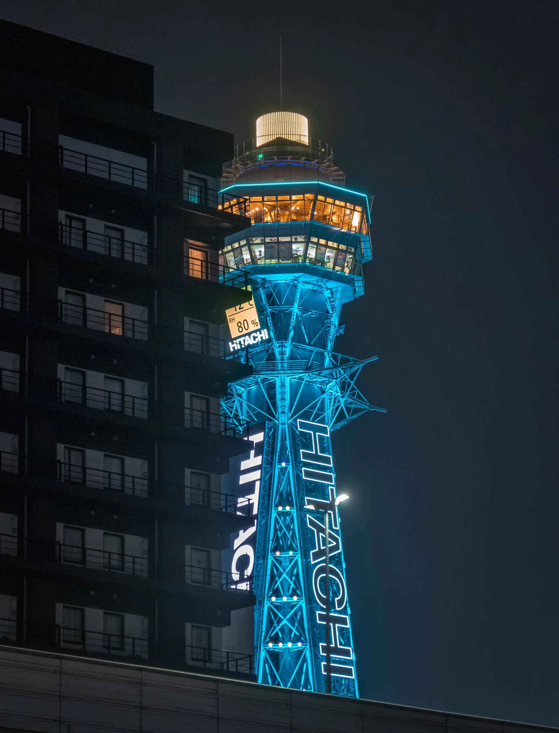Tsutenkaku peeking around the corner from a building
