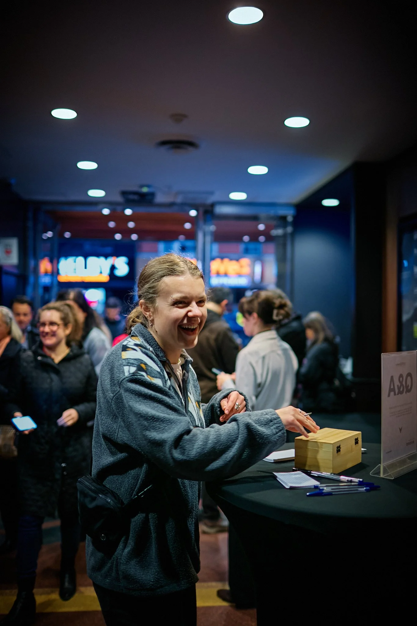  A person smiling as they submit their questions about AI to Prof. Geoffrey Hinton 