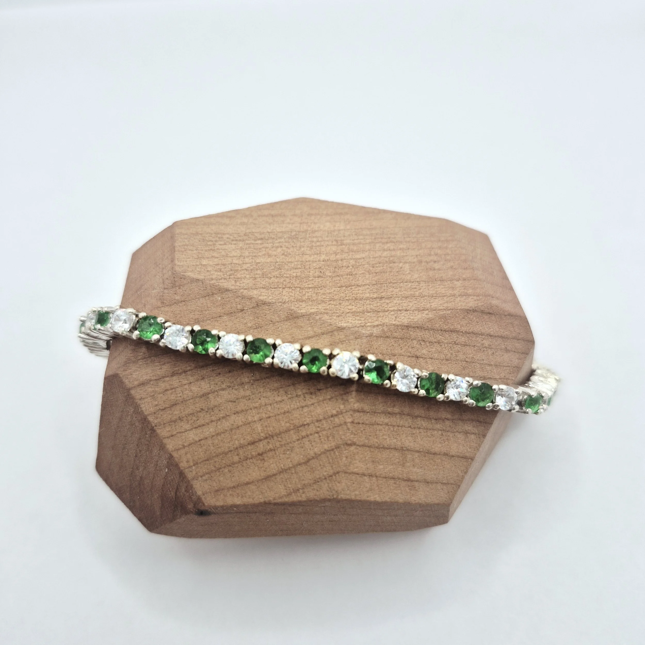 reen and white tennis bracelet on wood jewelry stand – 925 sterling silver
