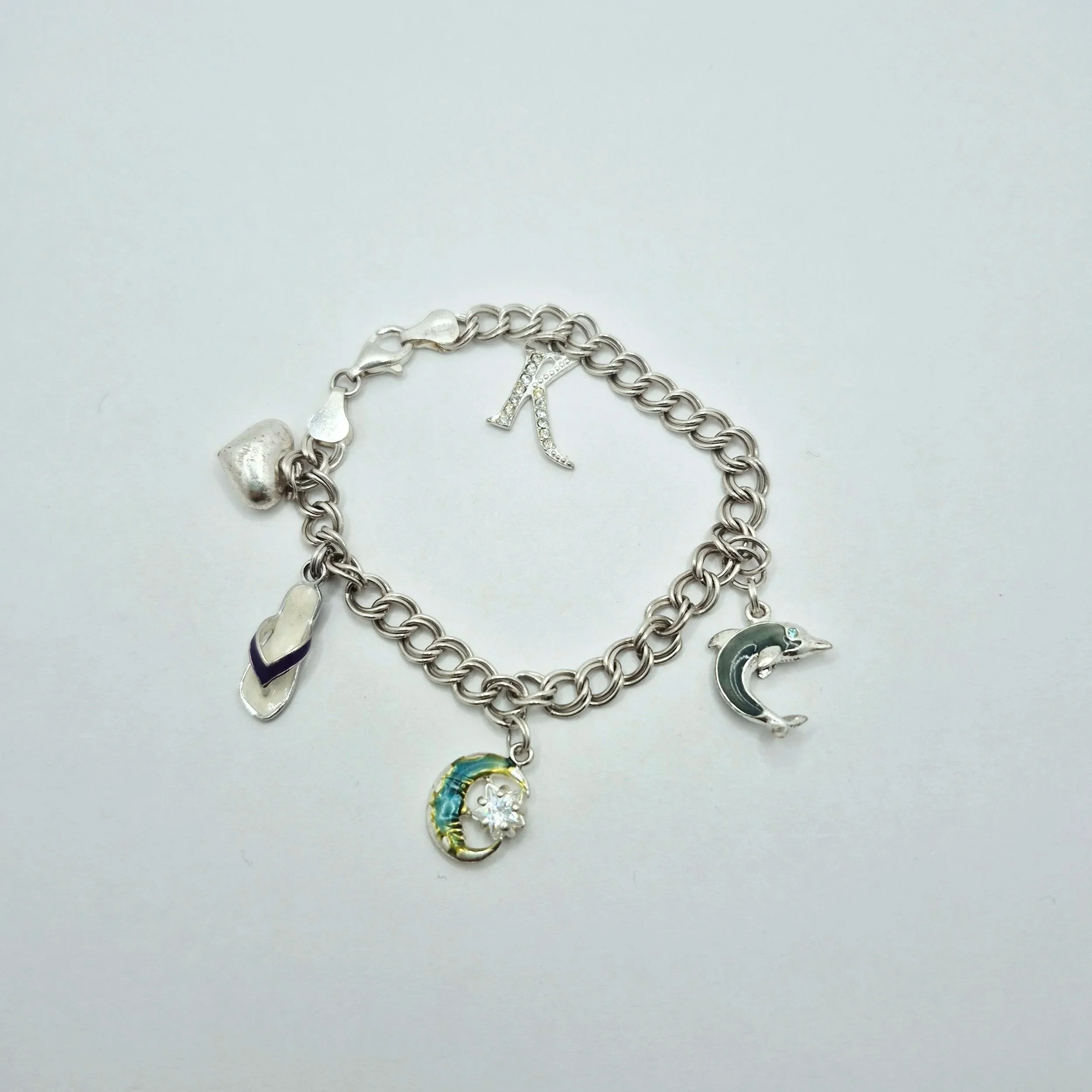 2️⃣ Playful 925 silver bracelet featuring tropical-inspired enamel charms and letter K