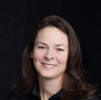 Elizabeth Buffardi smiling in front of black background