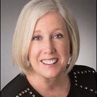 Karen Jones in black top smiling at camera