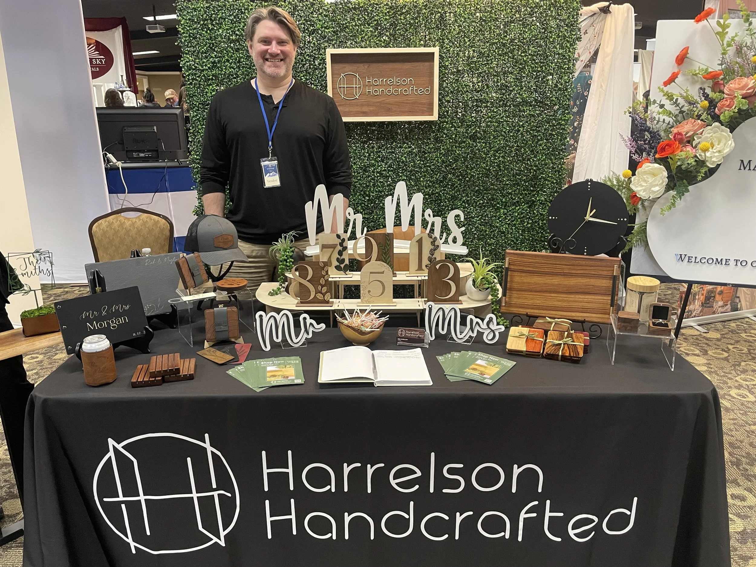 Rick Harrelson, owner of Harrelson Handcrafted, stands behind a table of his work and items for sale at the Whatcom County Wedding Showcase in March 2025.