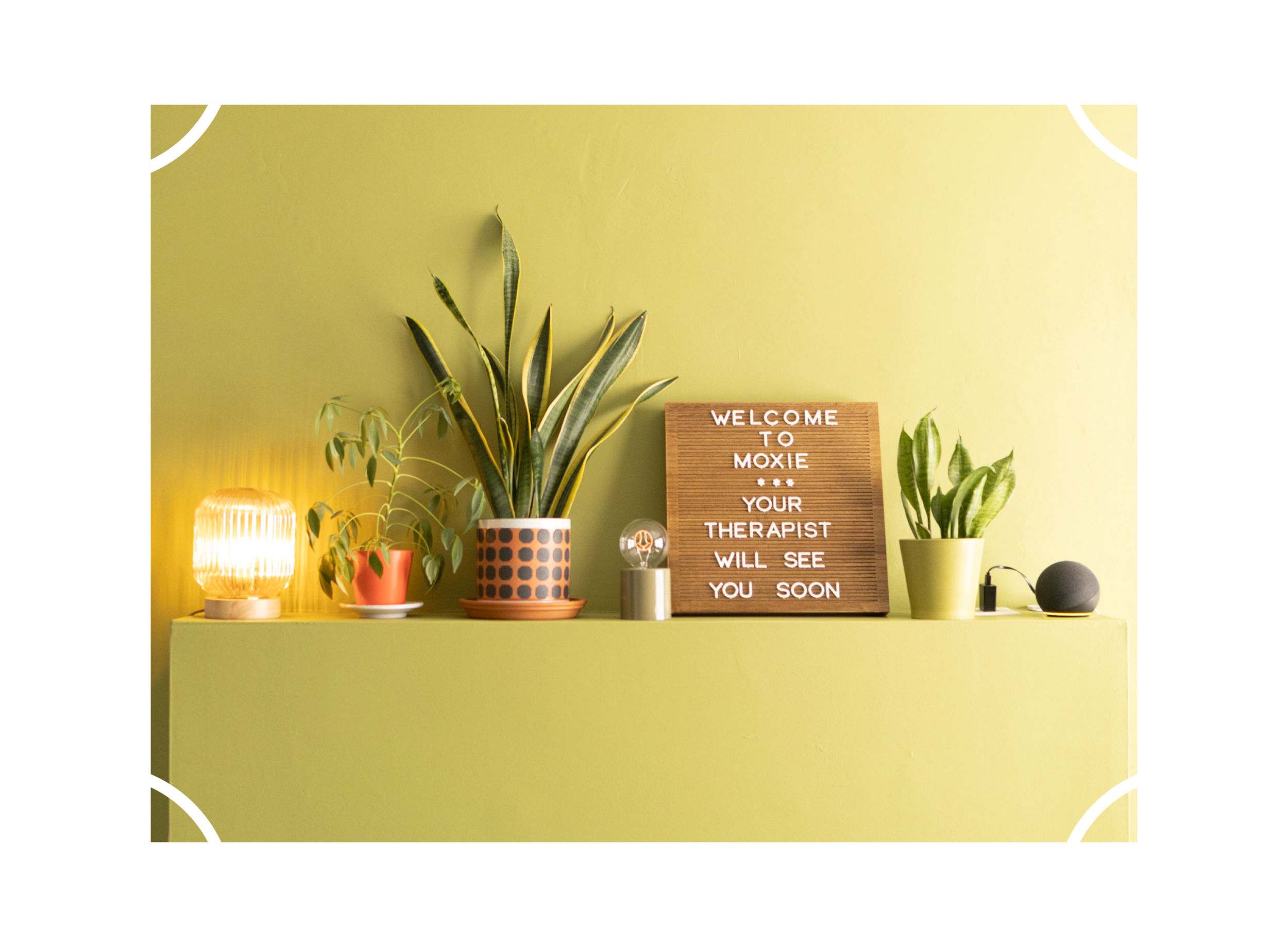 Cute decorations and a sign that says "Welcome to Moxie. Your therapist will see you soon" in the waiting area at Moxie Counseling in Wichita, Kansas