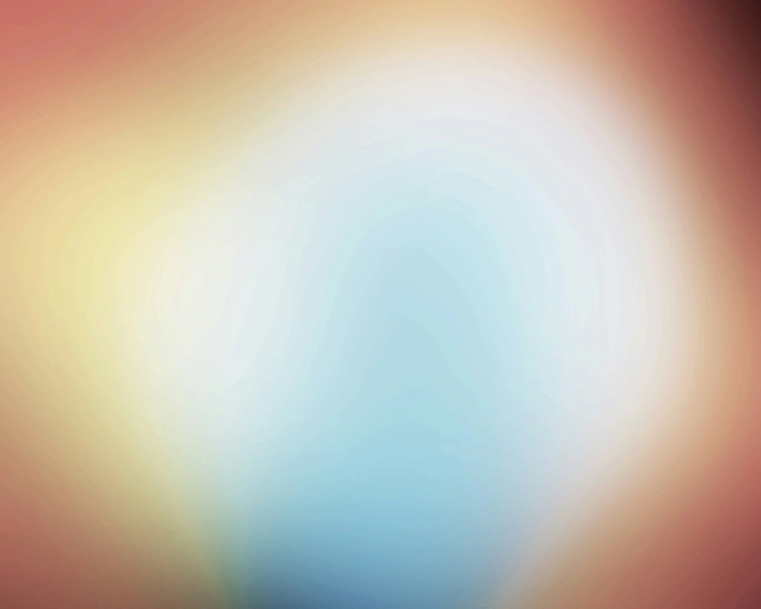 Blurred colorful background with a gradient of warm and cool tones.