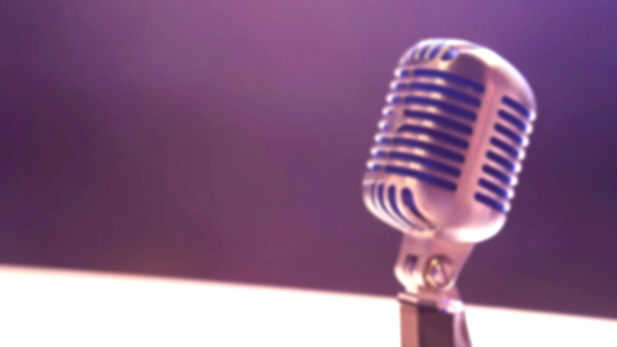 Close-up of a vintage microphone on a stand against a purple background.