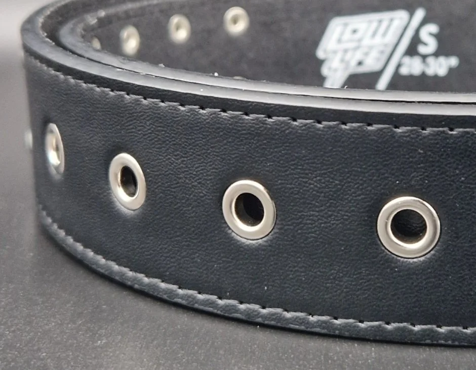 Leather belt with metal eyelets