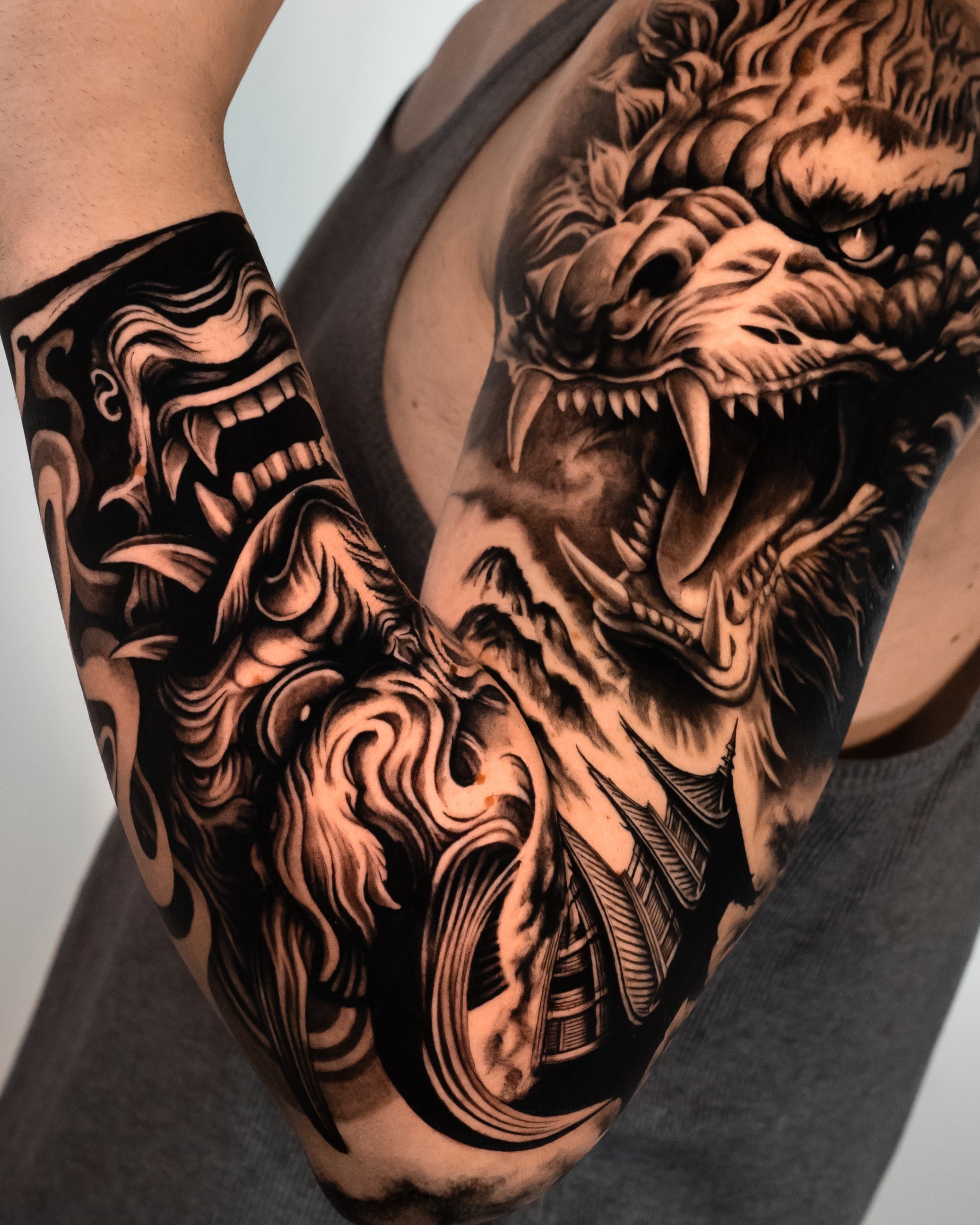 Close-up of a person's upper arm and shoulder with detailed black and gray tiger tattoo.