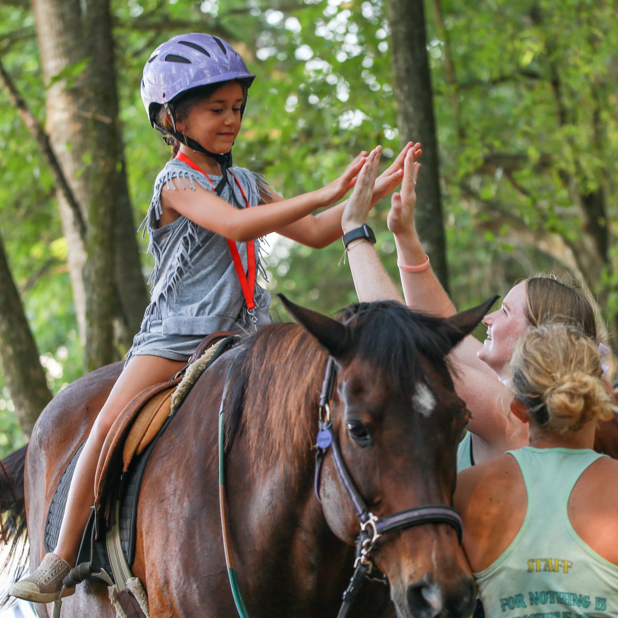 Makayla high five riding camp 2025.jpg