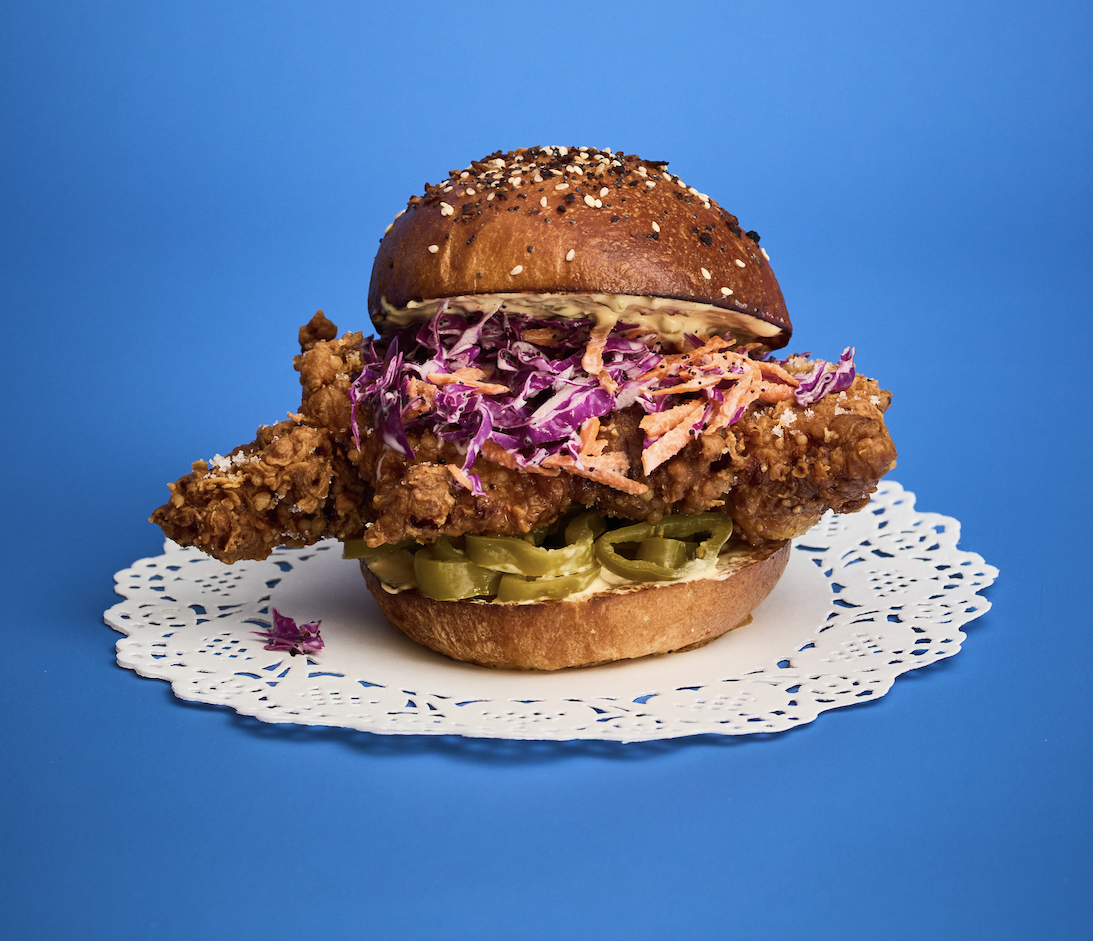 Pip’s Fried Chicken Sandwich features crispy fried chicken served on our house made milk bun with fresh coleslaw, pickled peppers, and smooth Calabrian chili mayo. This signature sandwich balances crunch, heat, and rich flavor, making it one of the m