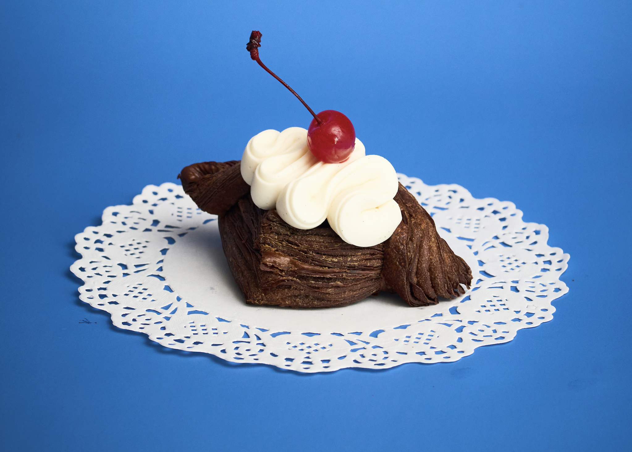 A flaky chocolate croissant, cherry jam, chocolate sponge cake finished with cream cheese frosting, and unmistakably Black Forest in spirit. 