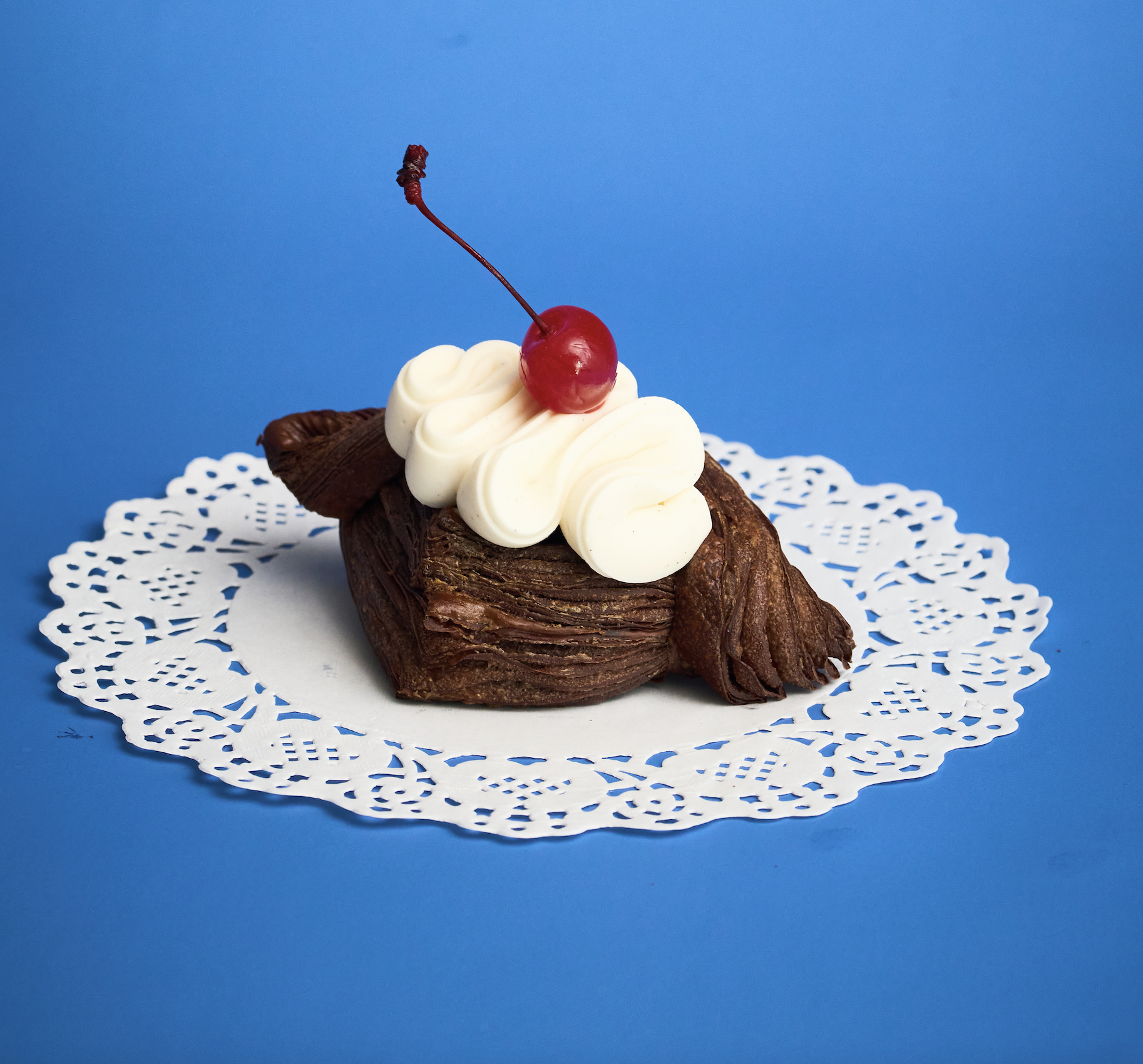 Our Black Forest Croissant features a buttery, flaky croissant filled with rich chocolate and tart cherry. Decadent yet balanced, it delivers deep cocoa flavor and bright fruit notes in every bite.