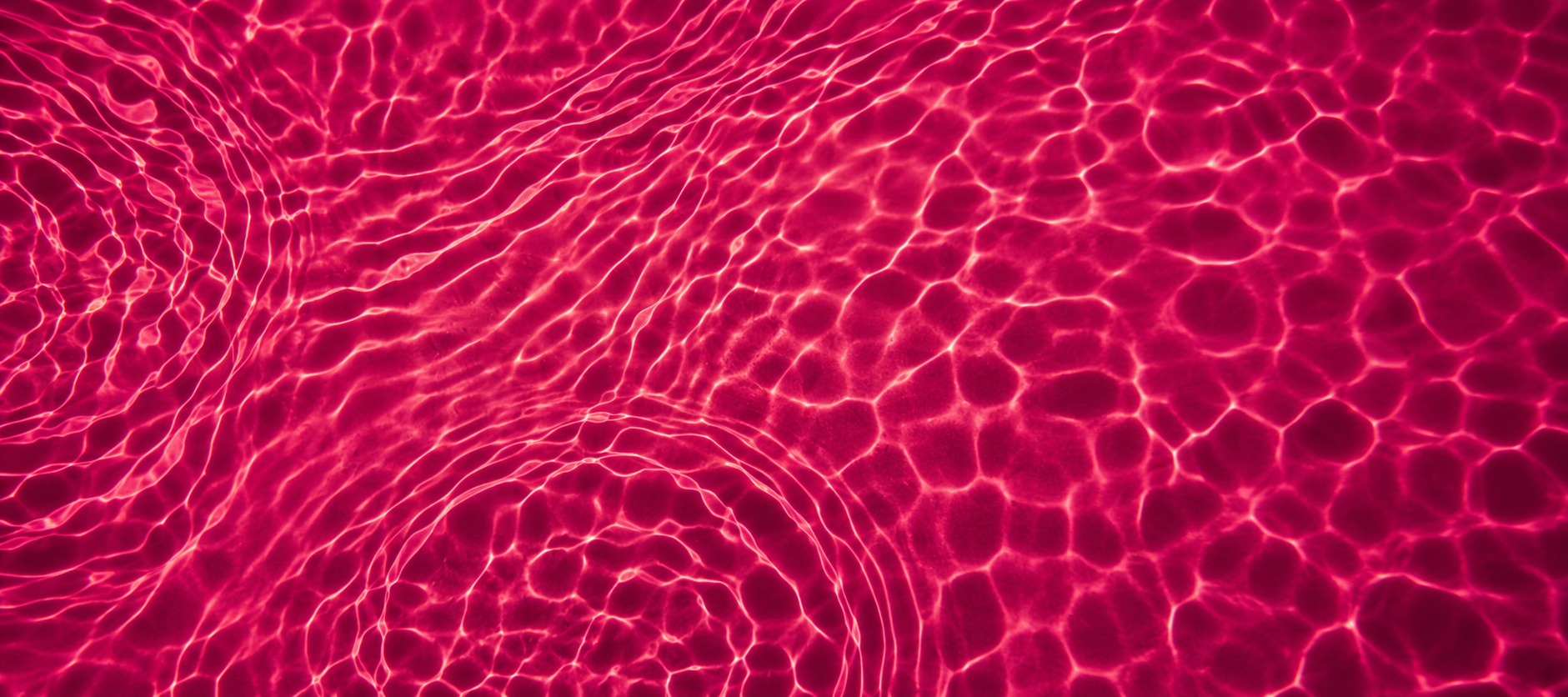 Nahaufnahme von leuchtend pinken Wasserwellen auf der Wasseroberfläche