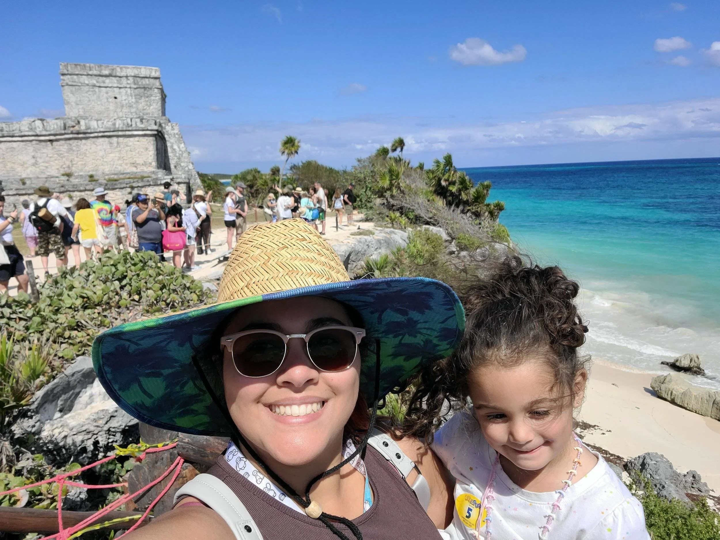 Mother and daughter taking at the mayan ruins in mexico.