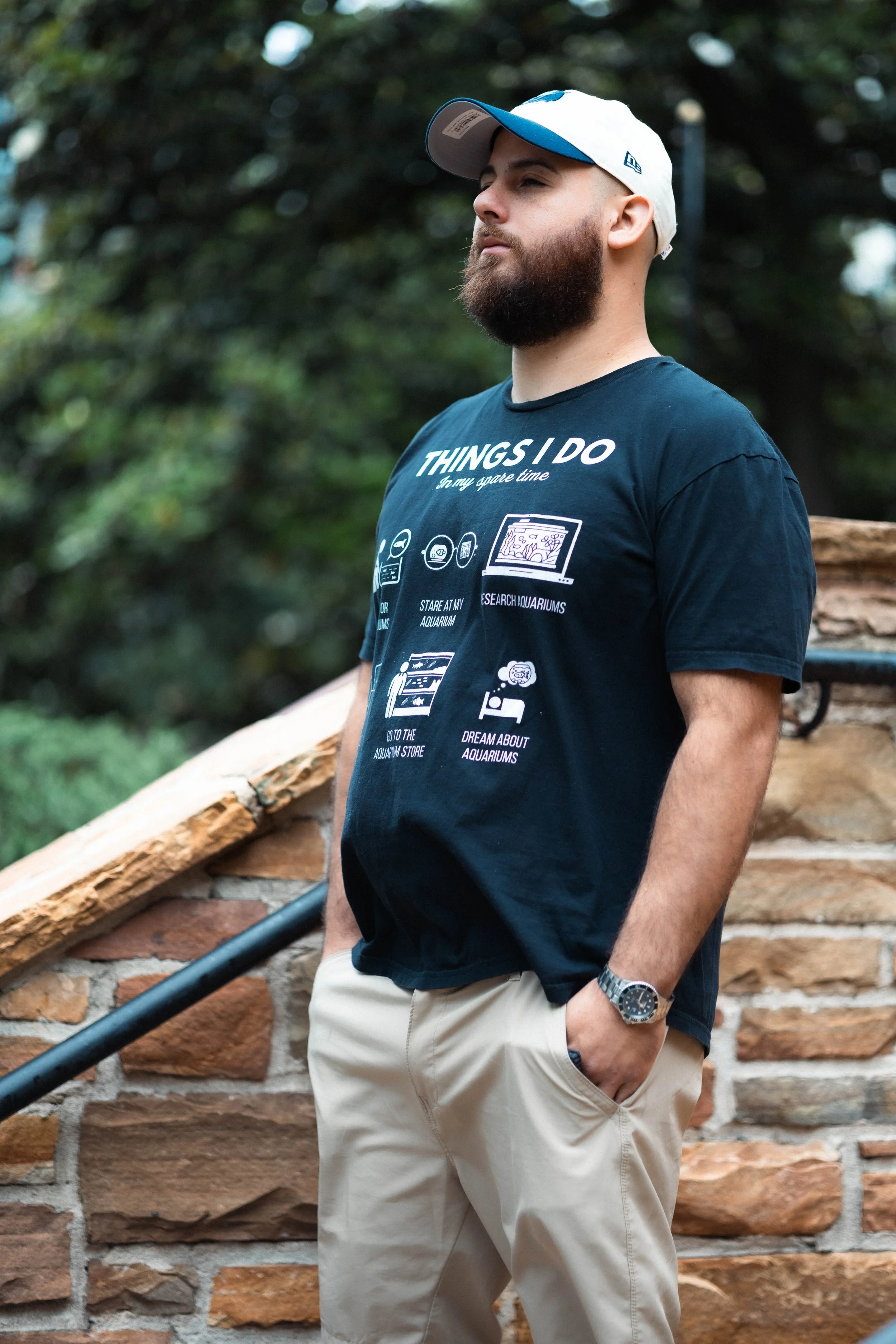 Man standing on a brick staircase looking away.