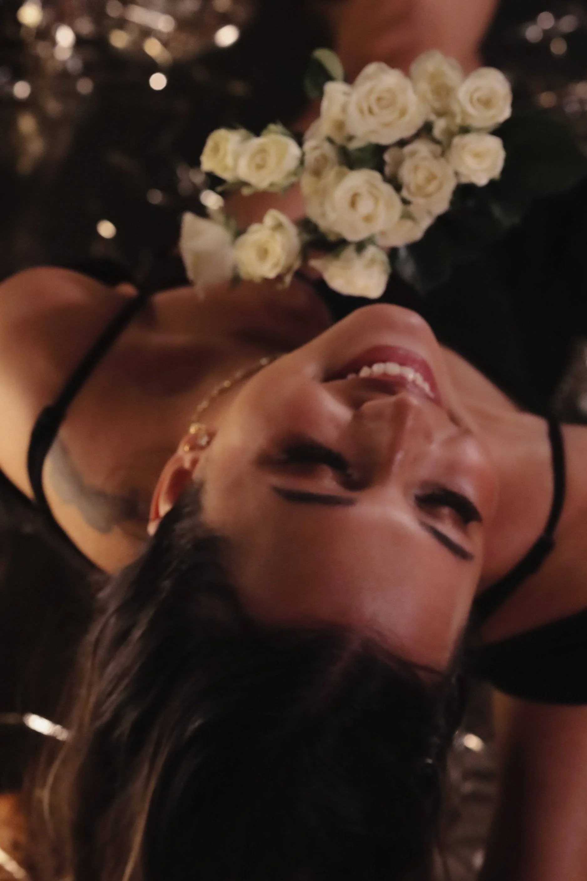 young woman holding flowers and smiling.