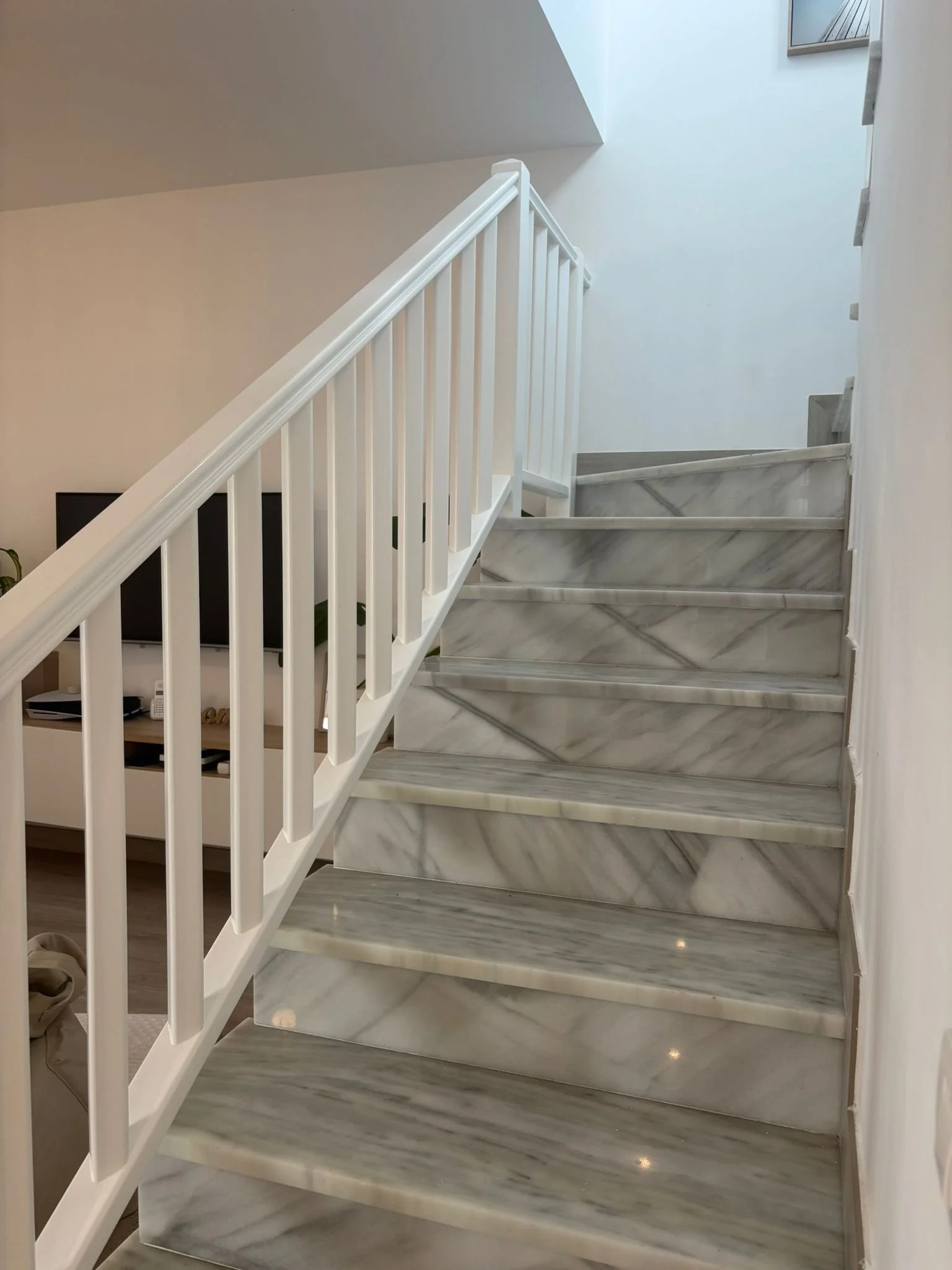 Marble staircase with white railing in modern interior