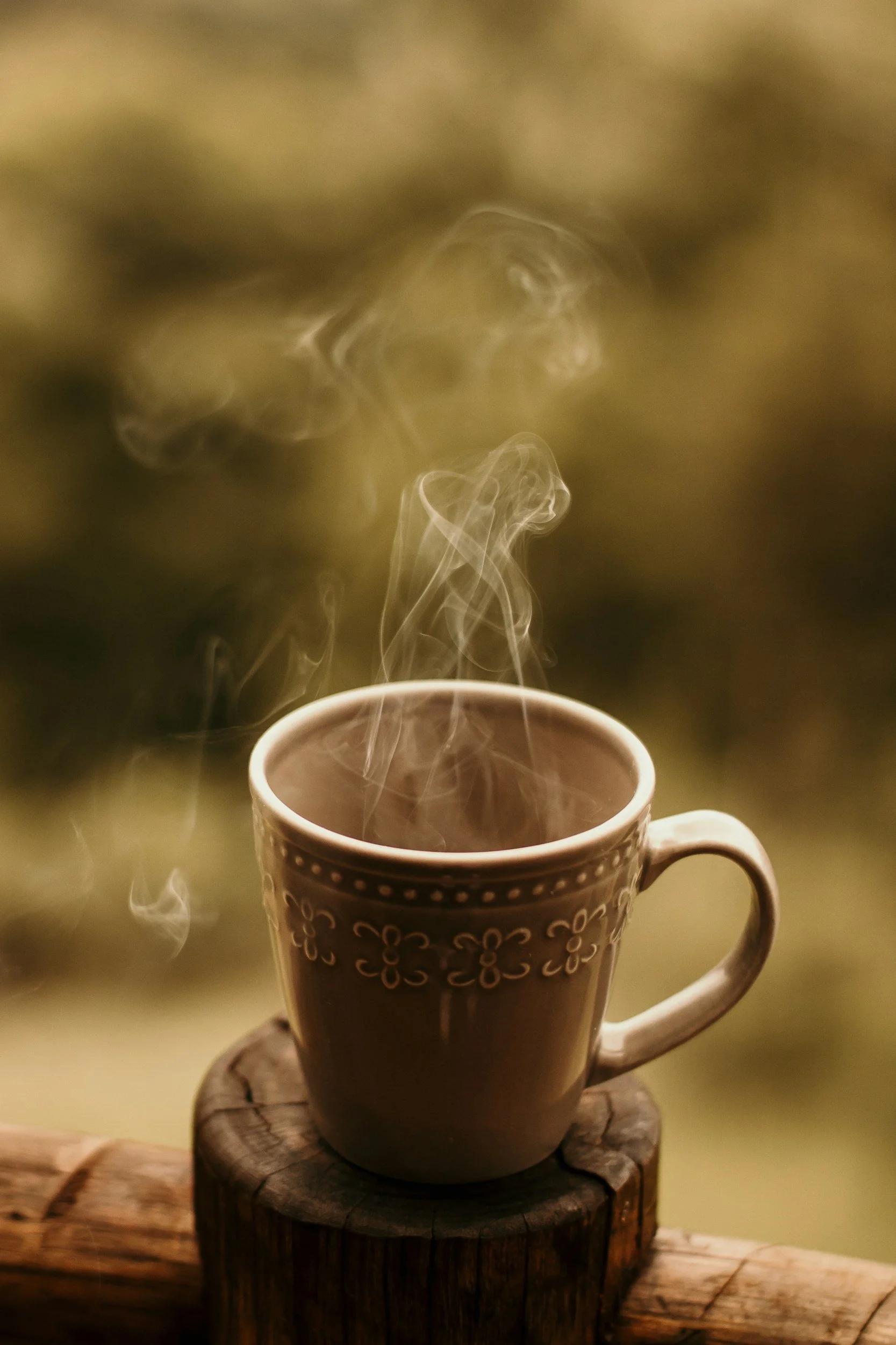 Coffee mug with steam in moody lighting and calming atmosphere