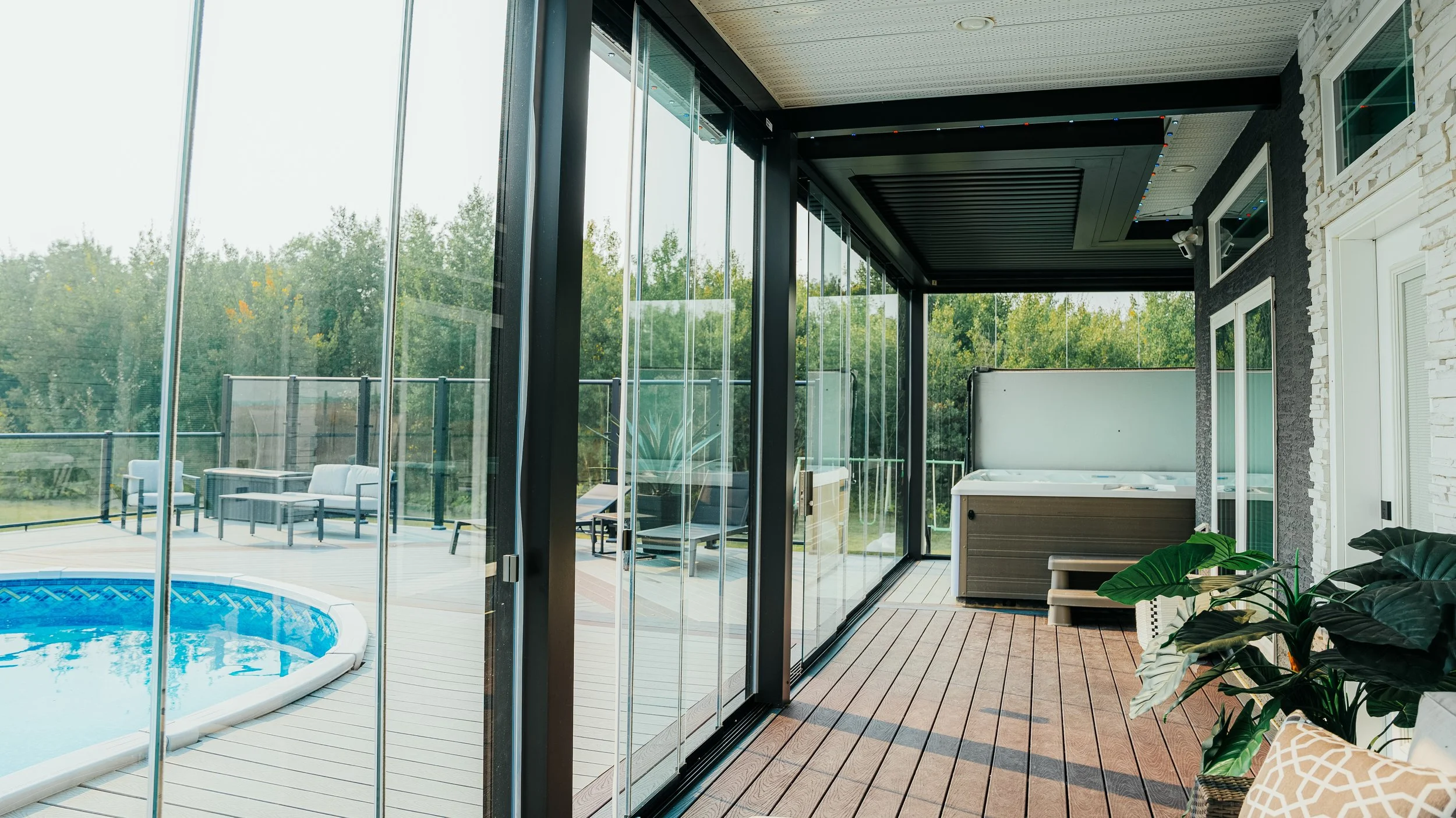 Structure pergola with lumon sliding glass walls for privacy.
