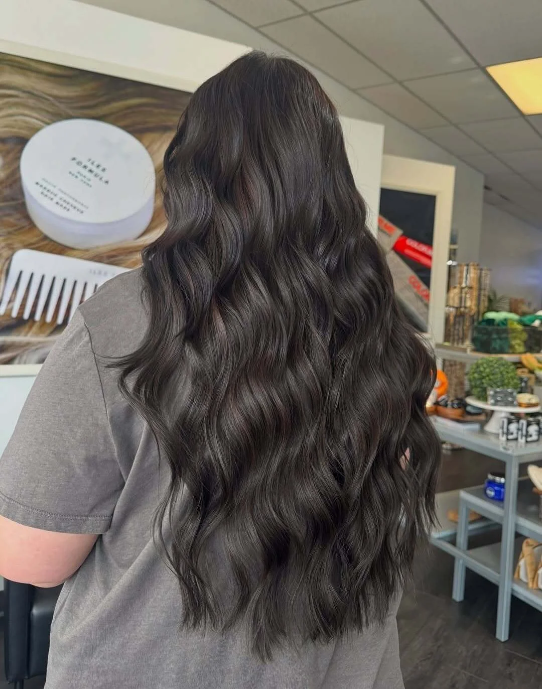     Dimensional brunette hair extensions with soft waves and seamless blending for natural volume and length.