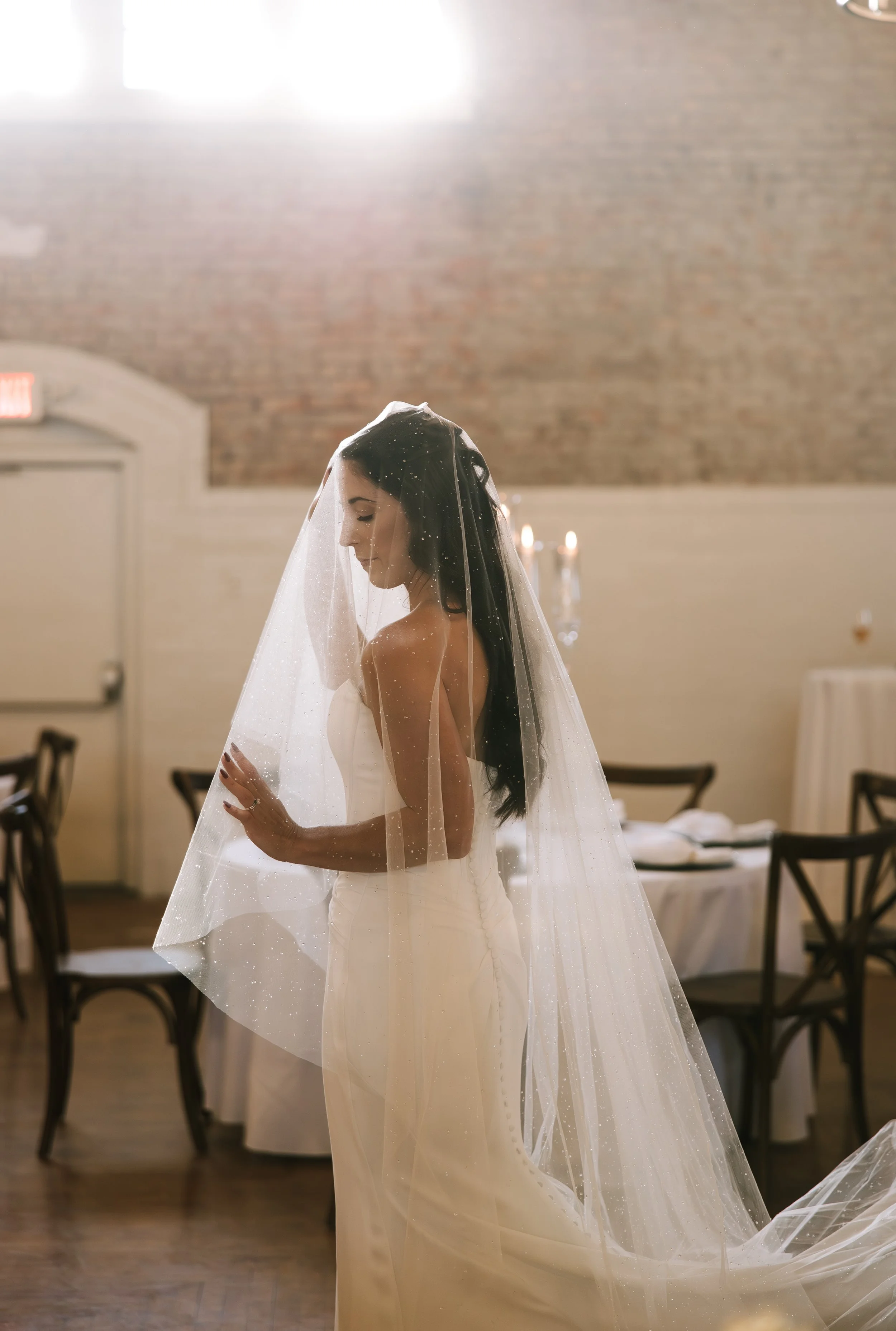Bride with a veil standing inside The ARMORY, Saint Marys, Ohio
