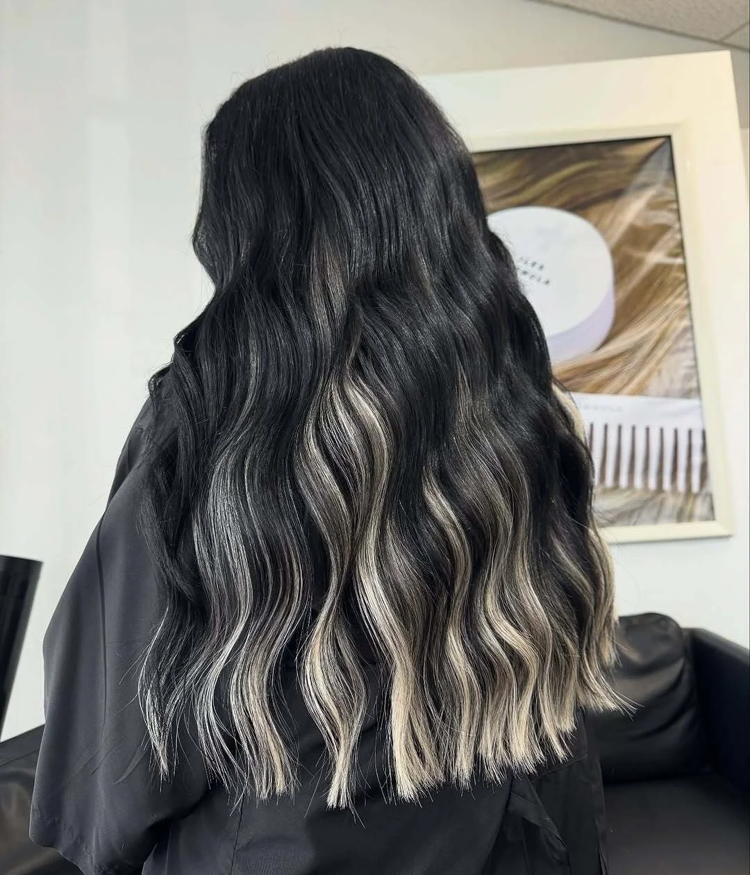     High contrast black and blonde dimensional hair color with long layered waves and extension blend at Studio H.