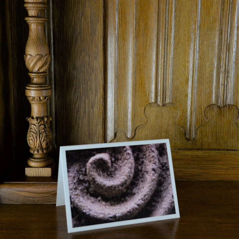 Raked Water Sculpture greetings card standing on a wooden mantelpiece