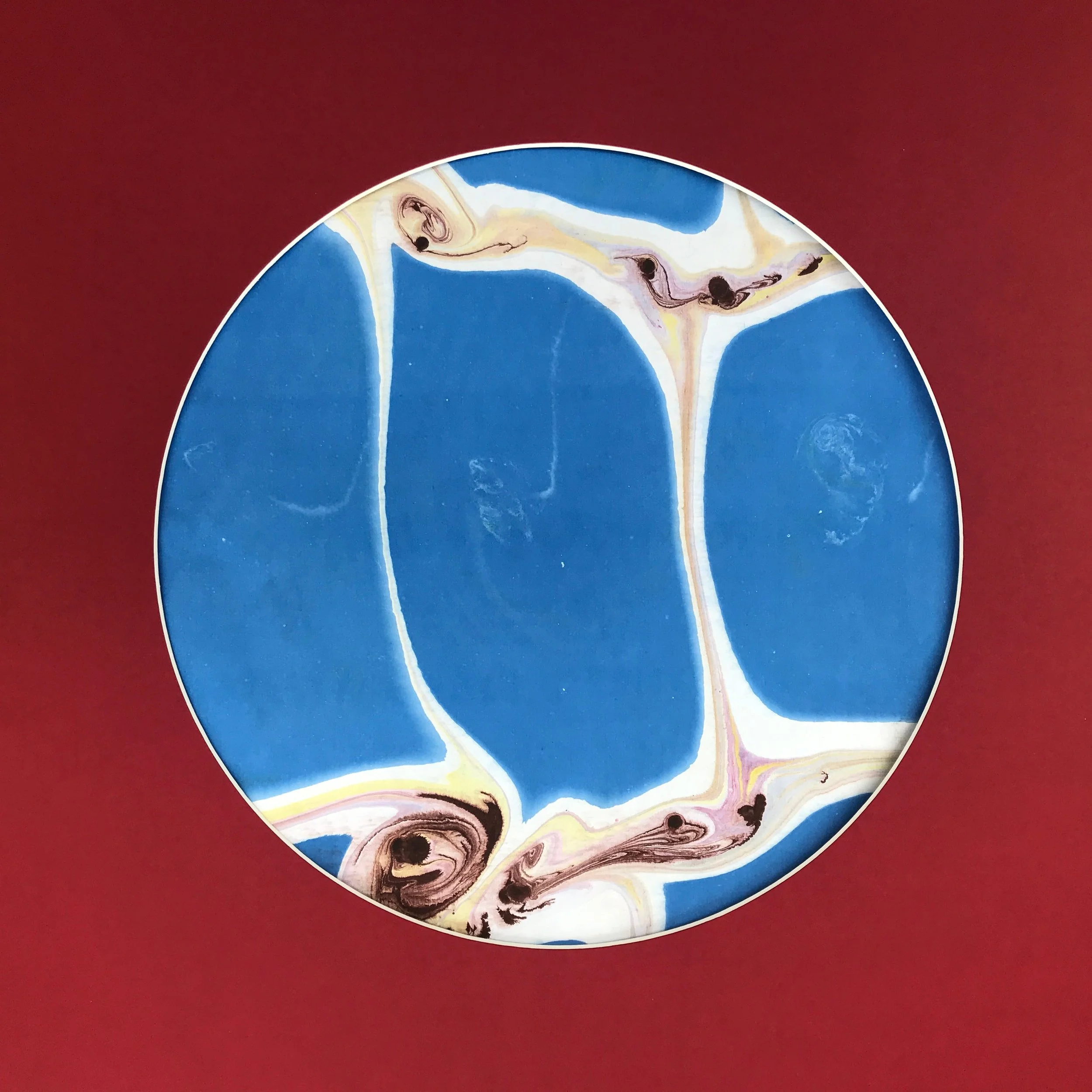 Rice Paddy Marbled Moon print, the blue and cream marbled pattern shown against a deep red ground