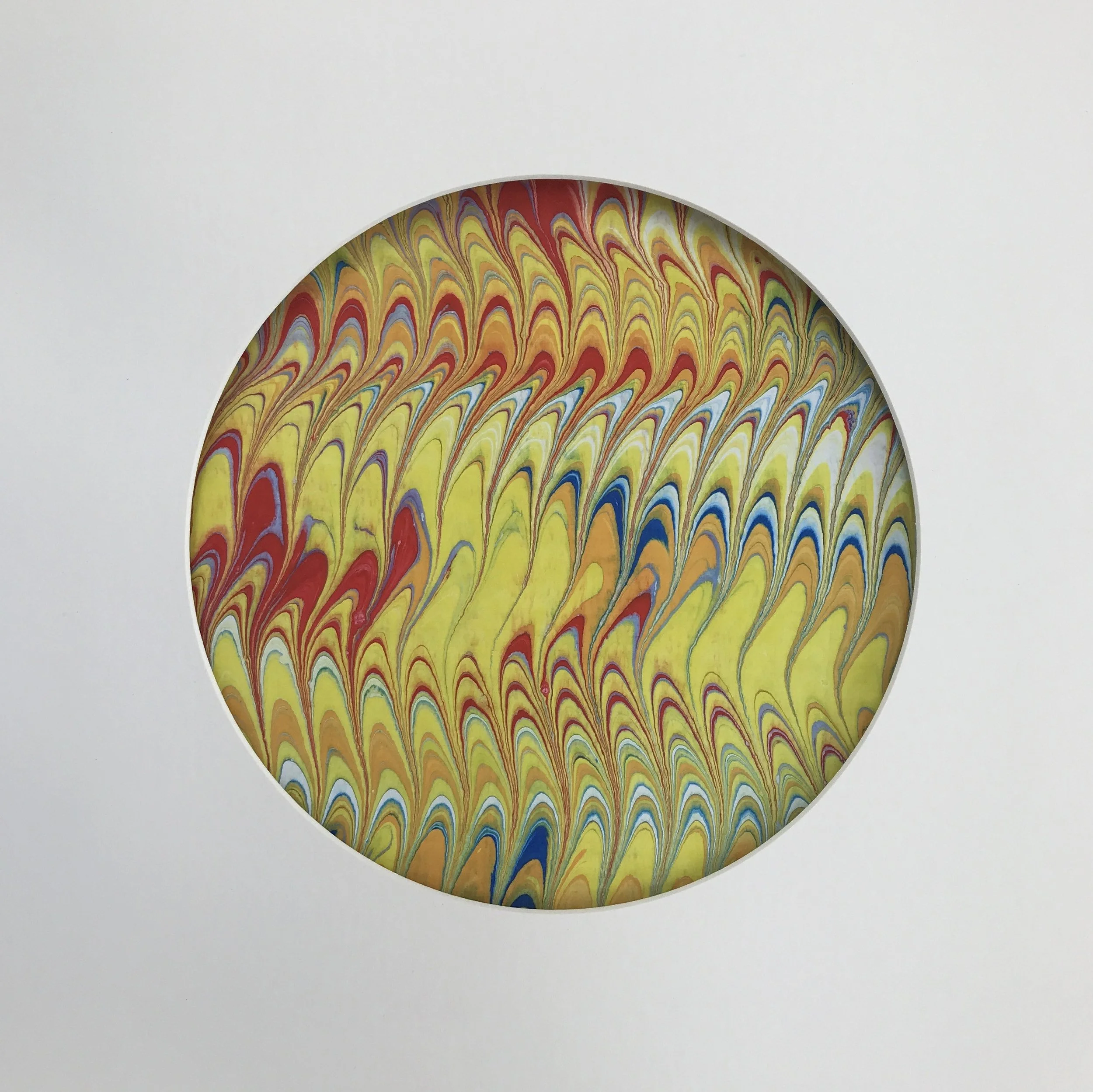 Calligraphic Yellow Marbled Moon print, a circular disc of finely combed yellow and blue marbling on cream