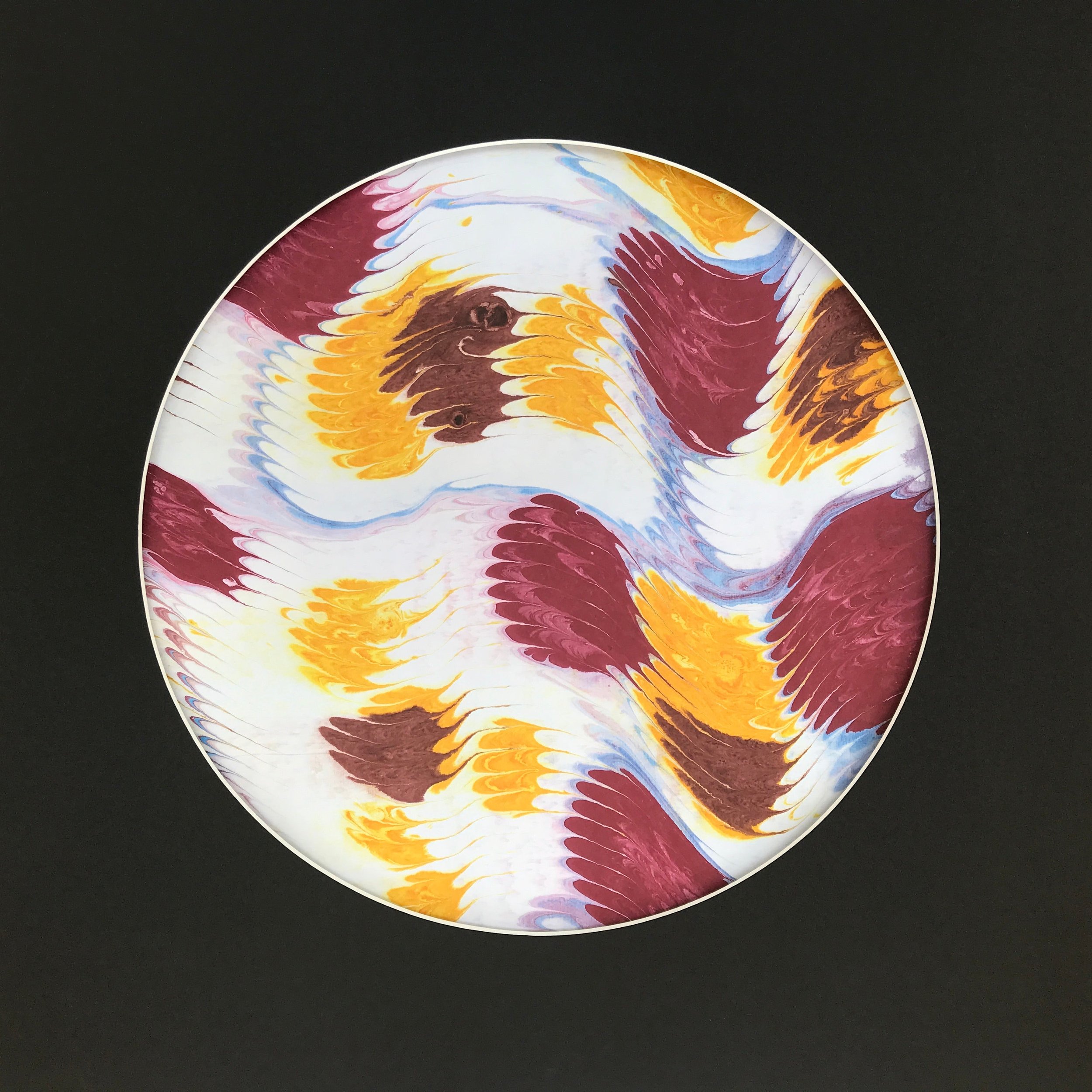 Geowave Marbled Moon print, the ochre and burgundy marbling shown against a black ground