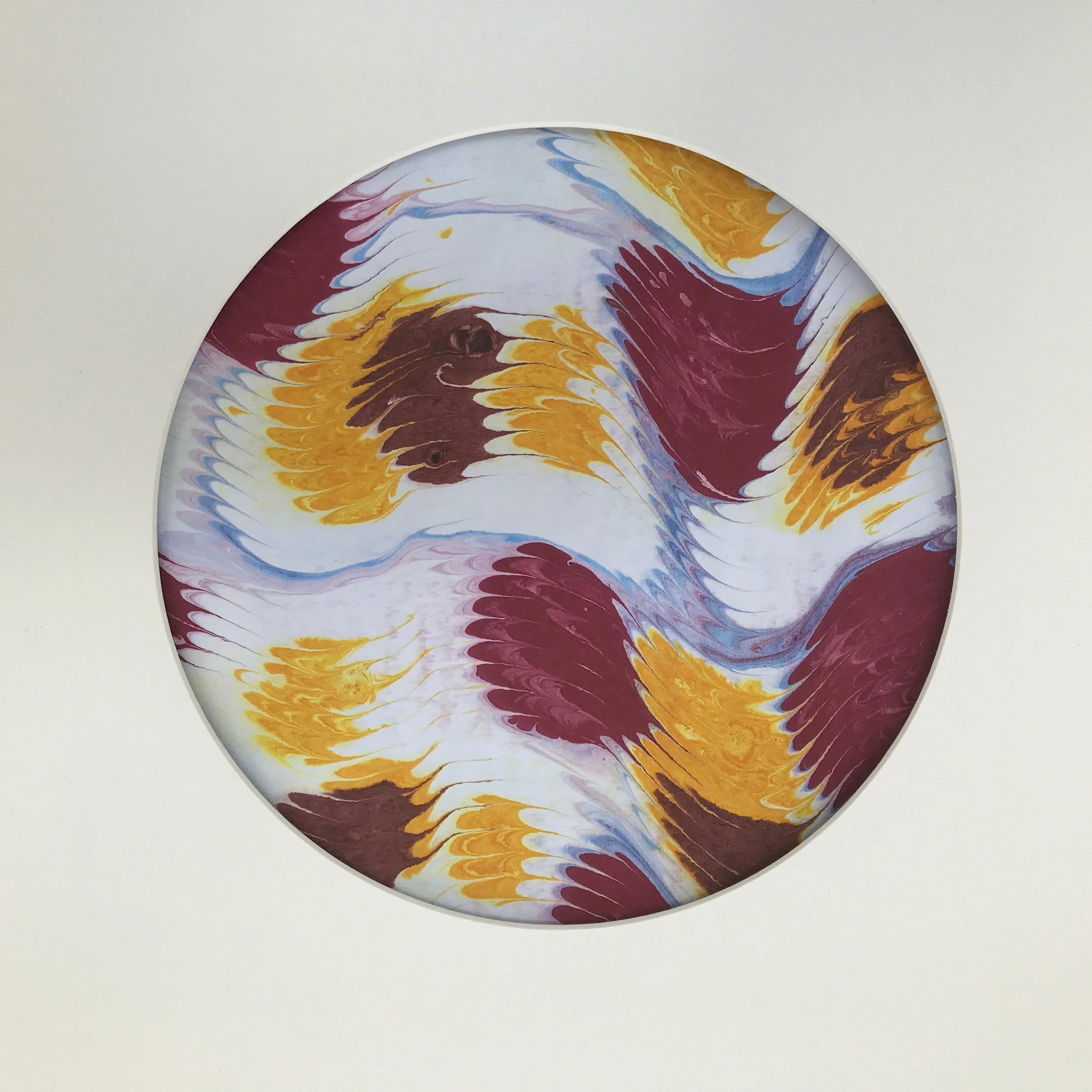 Geowave Marbled Moon print, the ochre and burgundy marbling shown against a pale cream ground