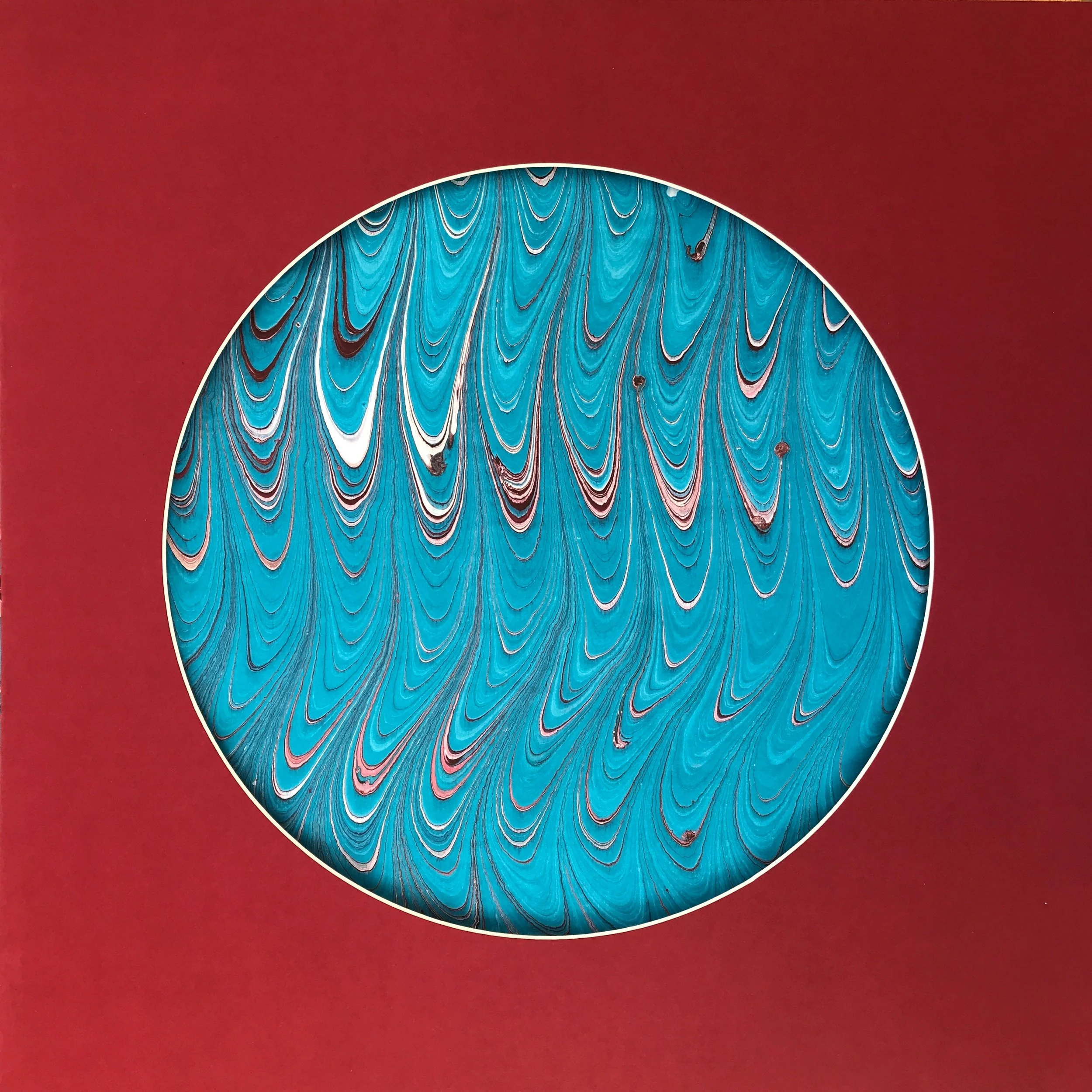 Feathered Blue Marbled Moon print, a circular disc of turquoise marbling combed into feathered plumes, on deep red