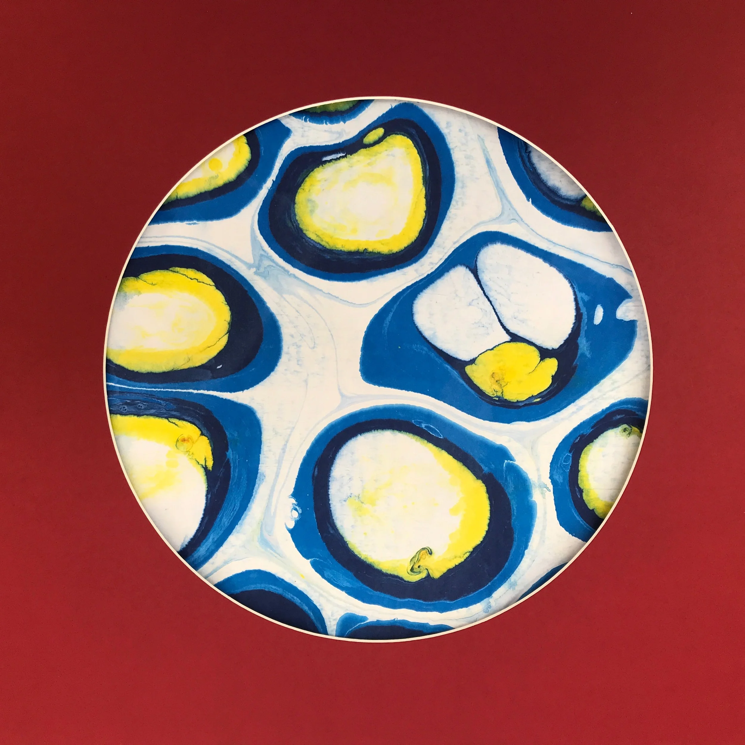 White Bubble Marbled Moon print, the blue and yellow bubble marbling shown against deep red