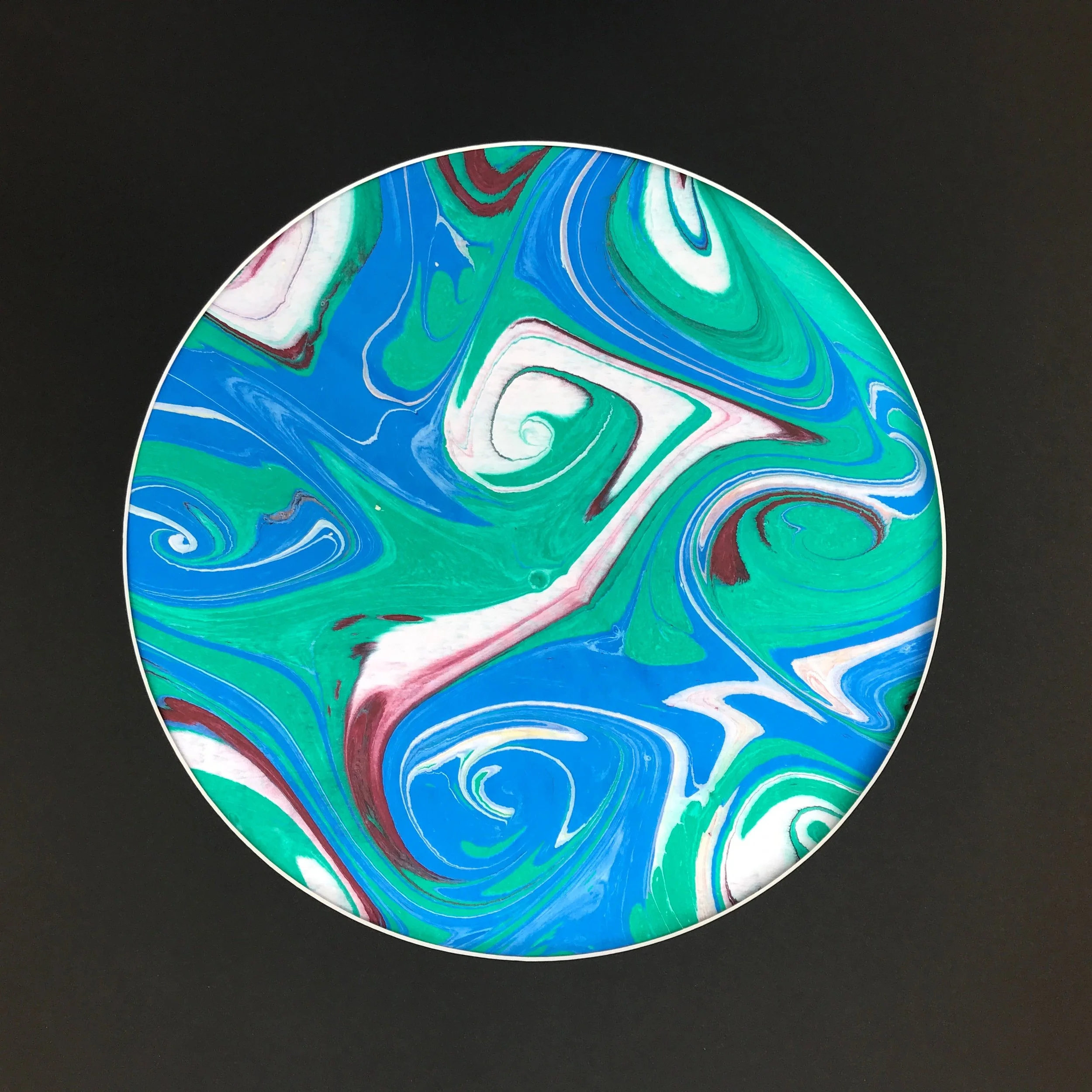 Green Marbled Moon print, a circular marbled disc of green, blue and white swirls on black